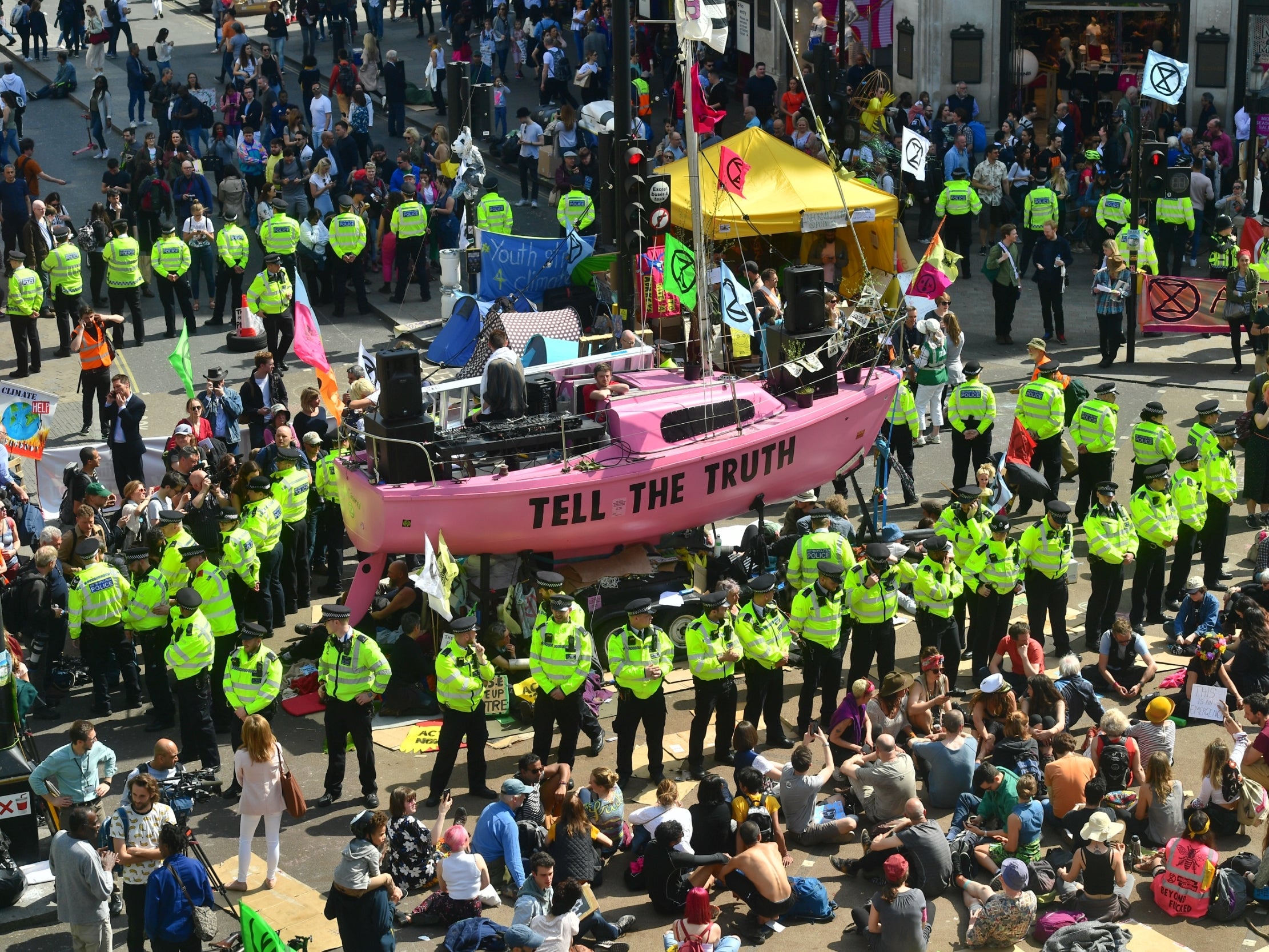 Police officers arrive at Oxford Circus as they prepare to remove protesters on 19 April 2019