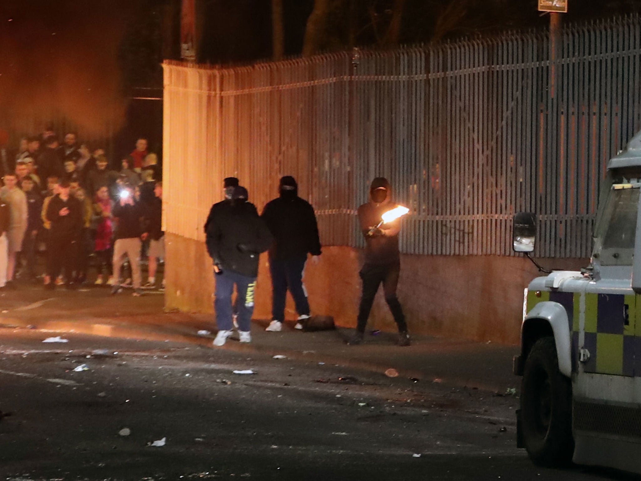 Four men throwing petrol bombs and missiles at police, shortly before a shooting in Derry on 18 April