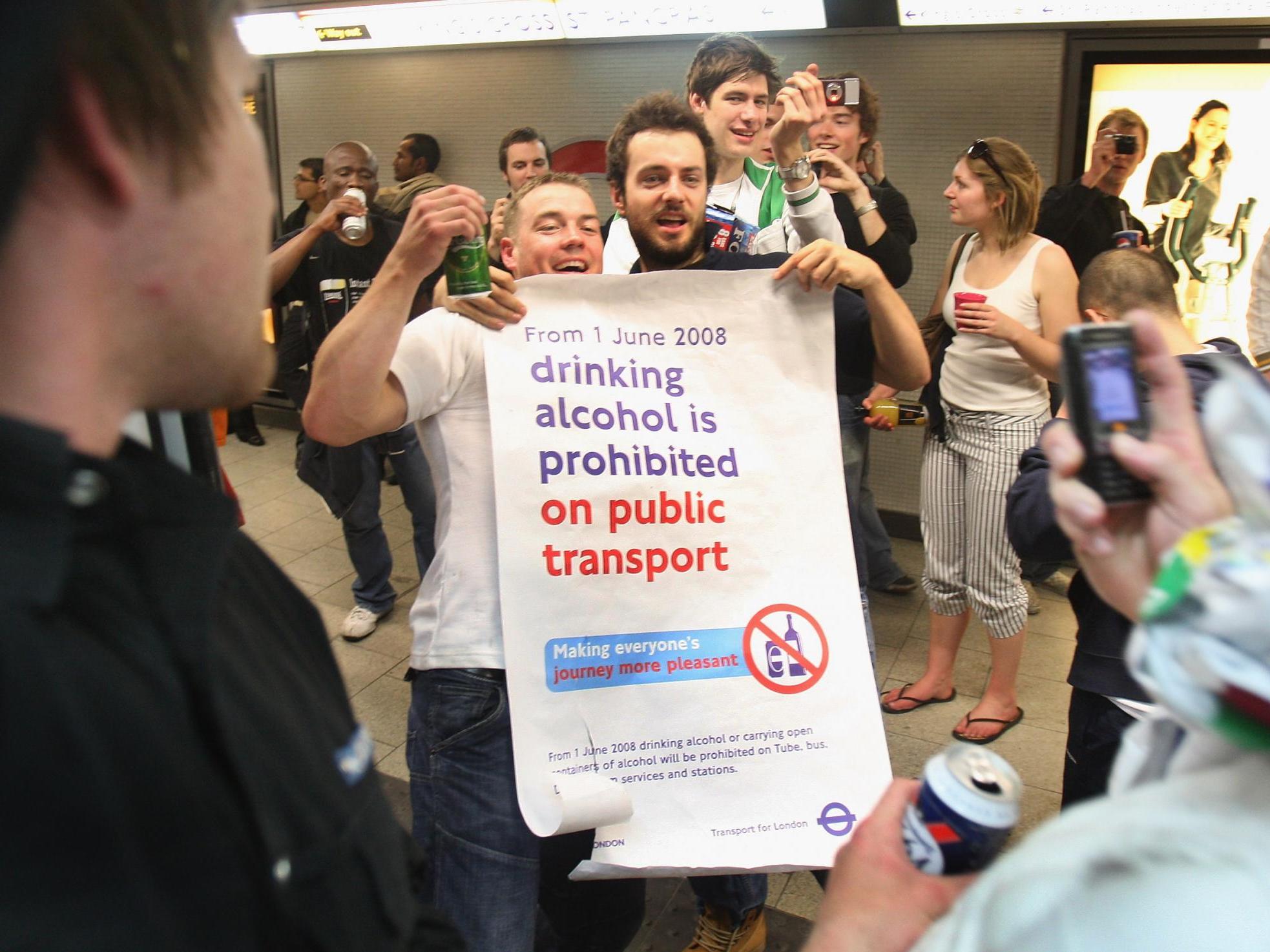 Partygoers join in a cocktail party on the London Underground on 31 May 2008, a day before the consumption of alcohol became illegal on public transport in the capital