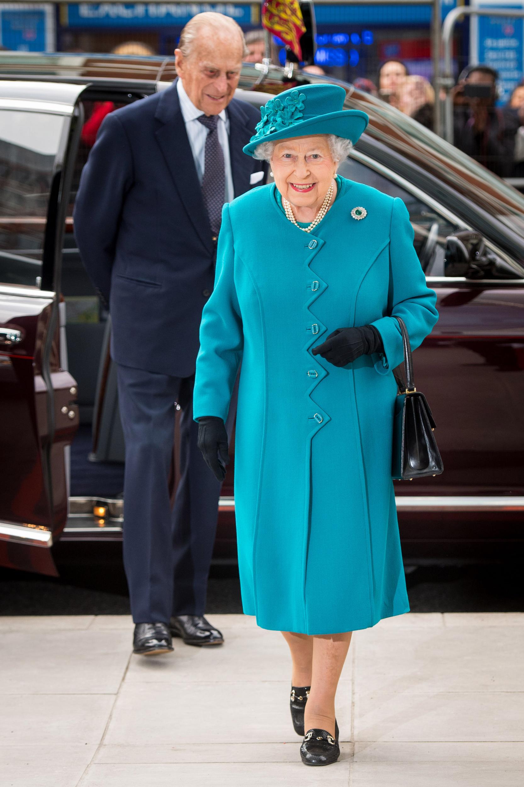 The Queen is pictured in an azure coat with a zig-zag buttoning detail as she attends the opening of the National Cyber Security Centre in London on 14 February 2017.