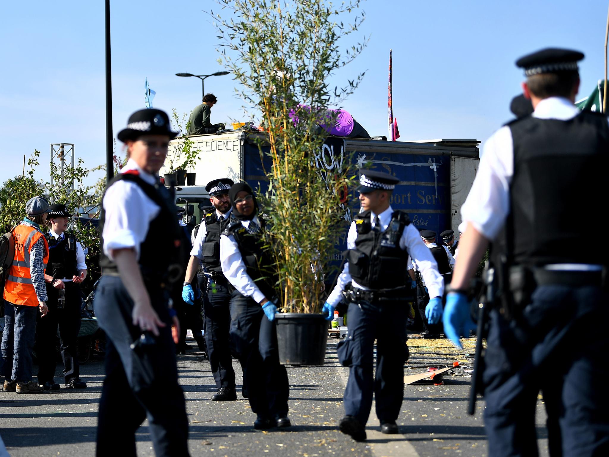 Officers remove plants that were placed in the occupation of Waterloo Bridge