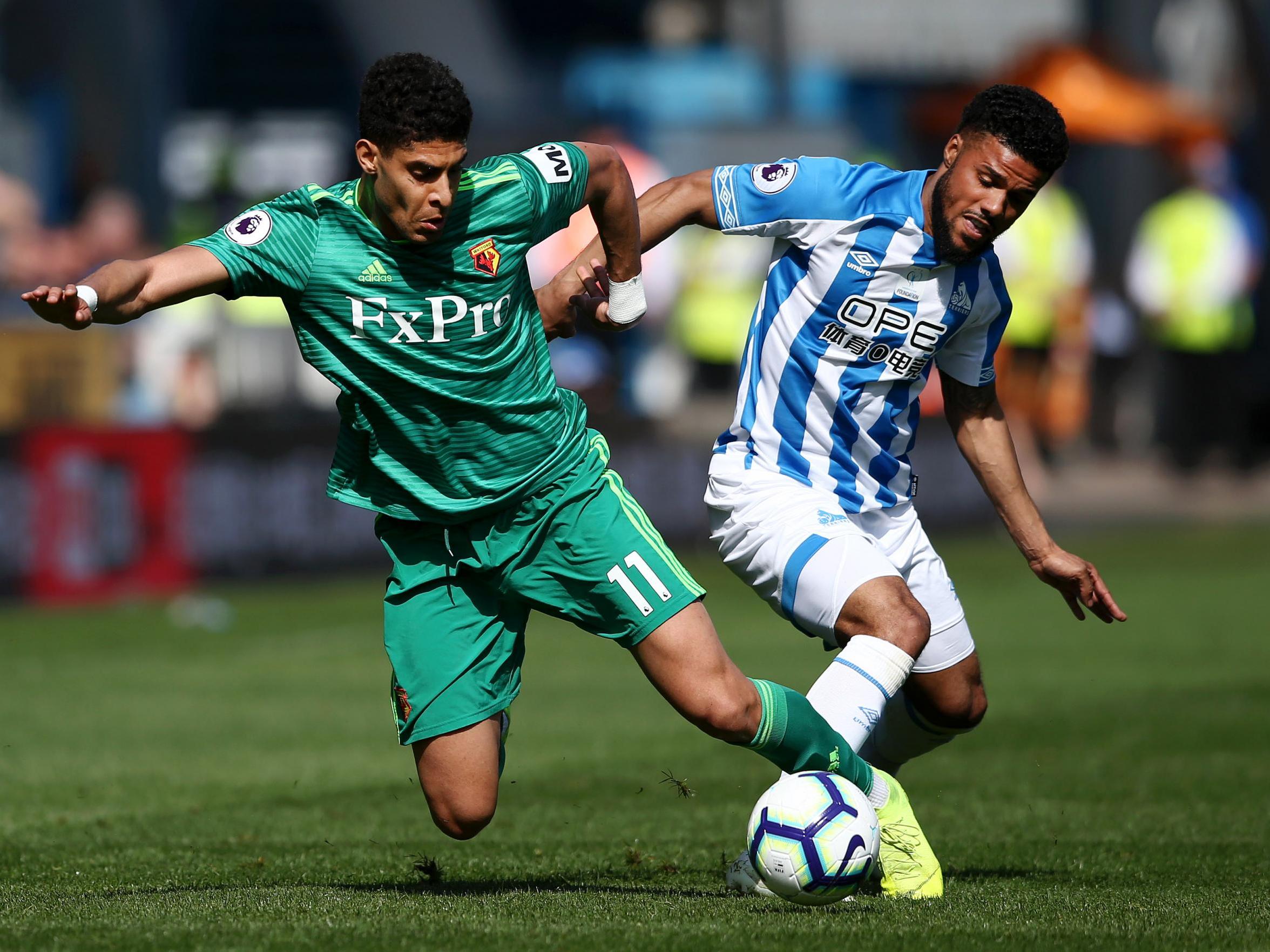 Adam Masina and Elias Kachunga tussle for possession