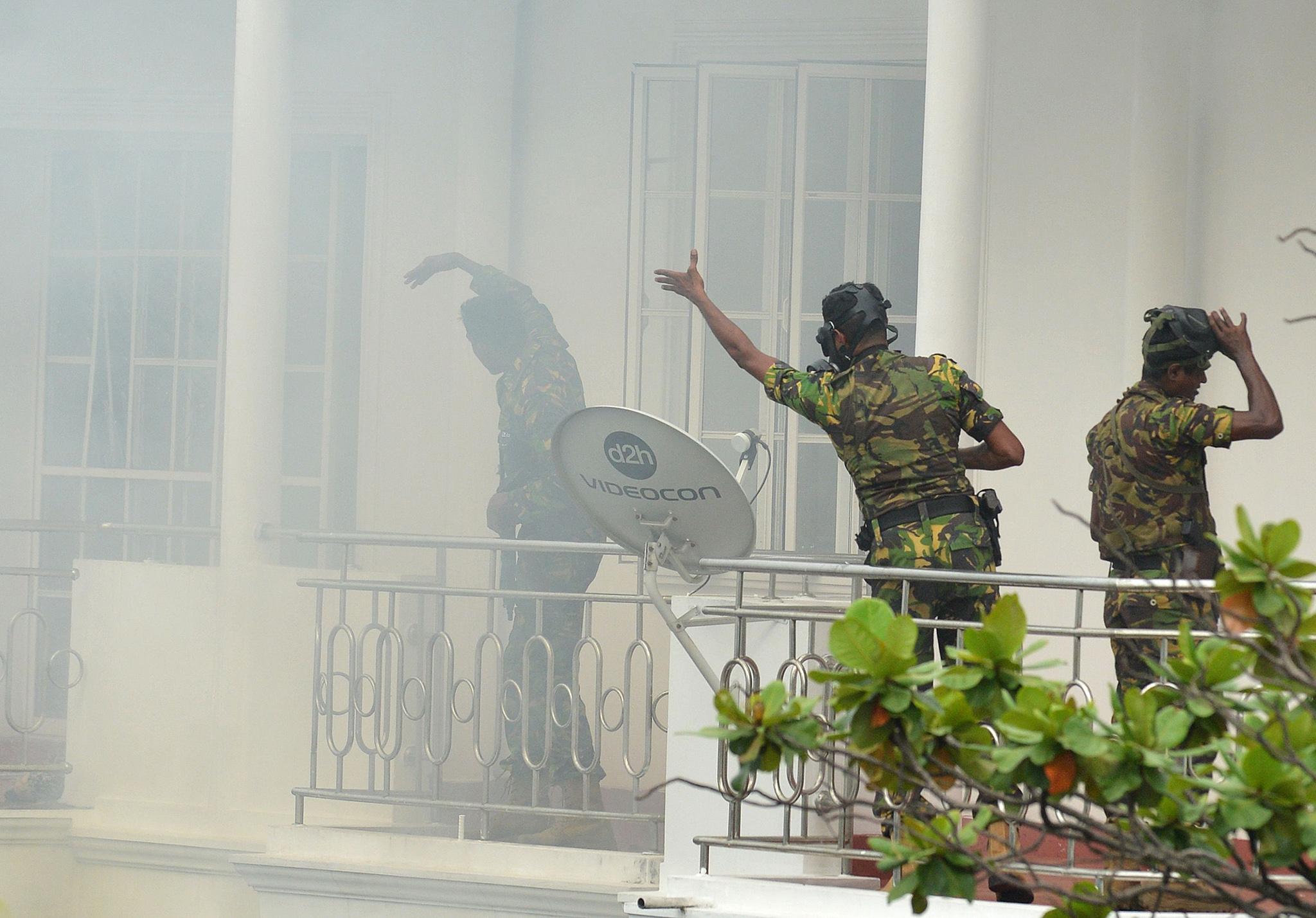 Sri Lankan Special Task Force officers raid a house following an explosion in capital Colombo