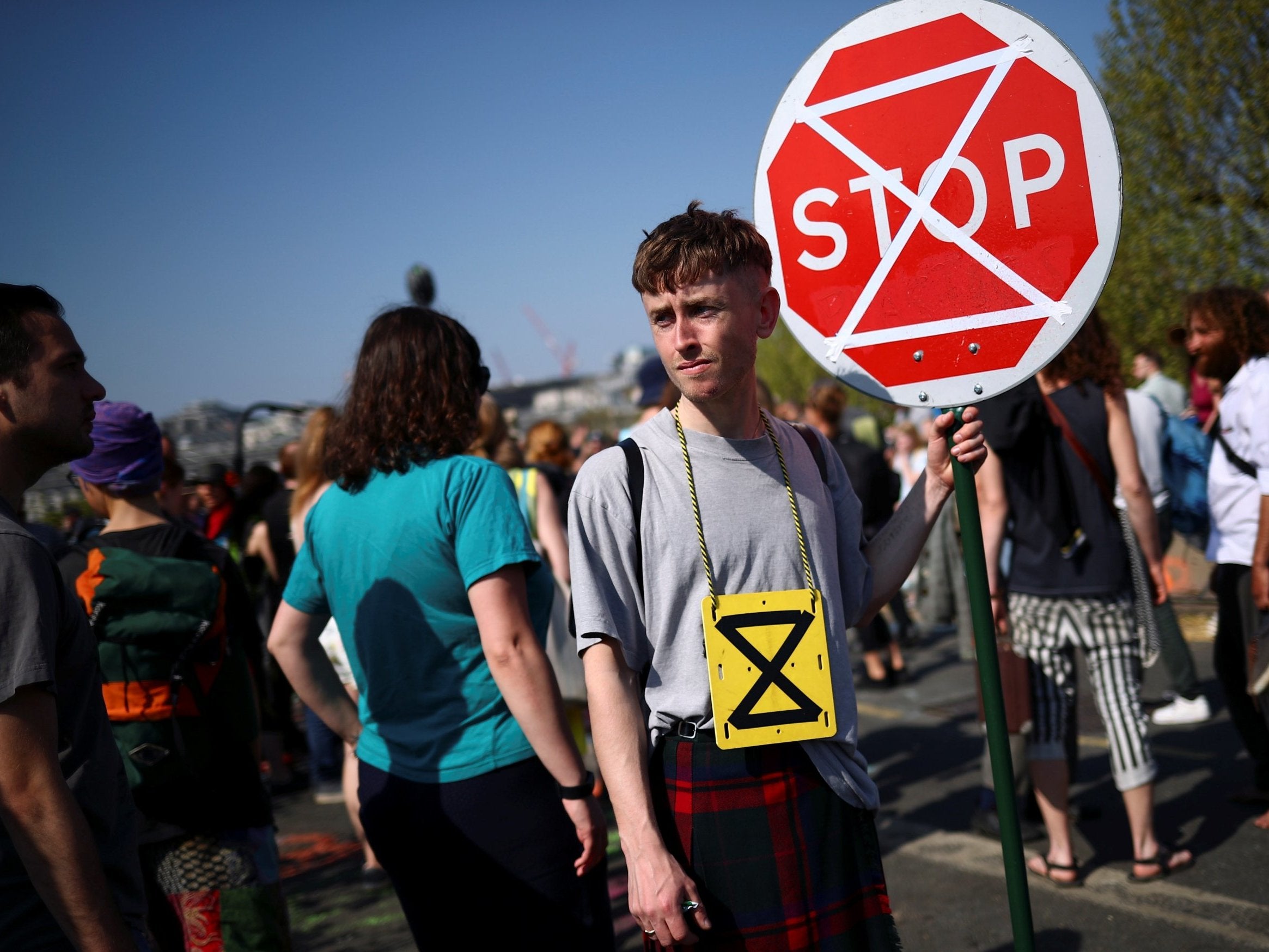 A climate change activist holds a sign during the Extinction Rebellion protest