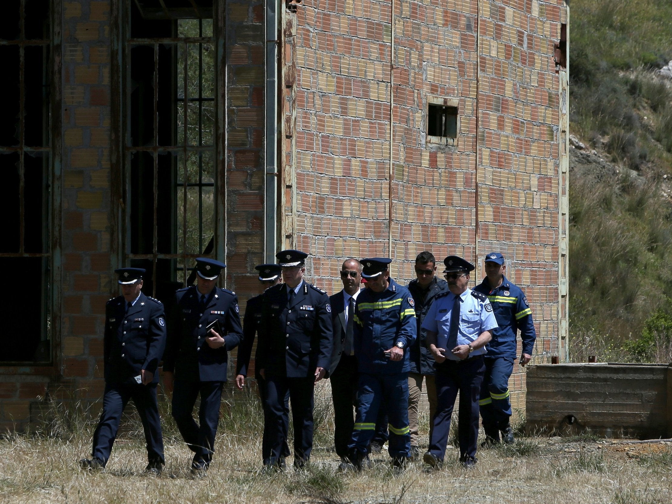 Chief of Cypriot police Zacharias Chrysostomou, centre, at the flooded mineshaft