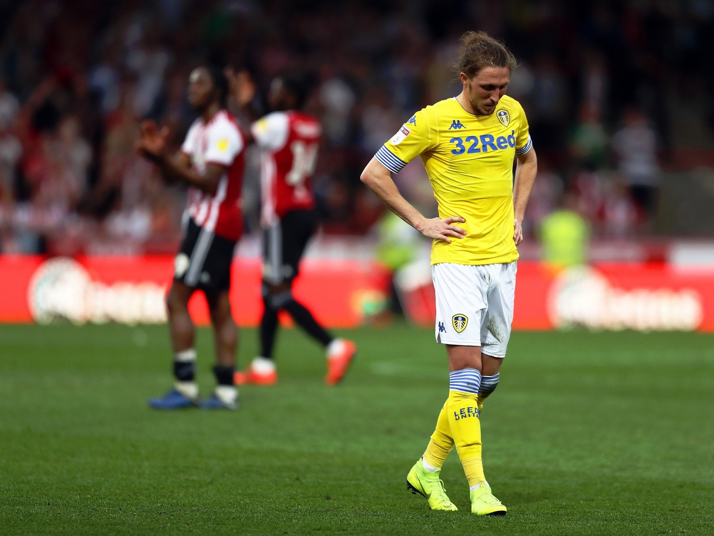 A dejected Luke Ayling looks on after defeat at Griffin Park