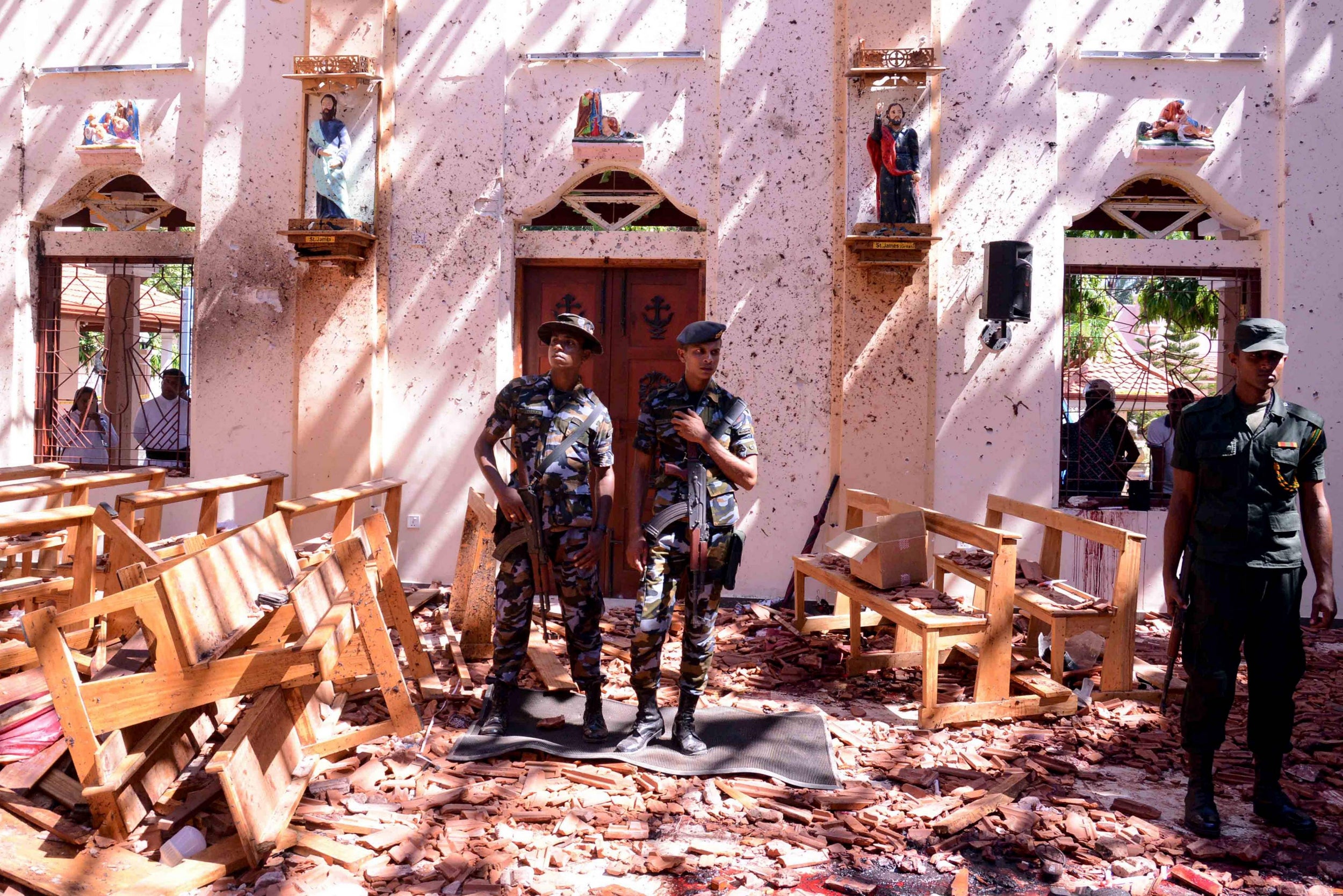 Sri Lankan soldiers look on inside the St Sebastian's Church at Katuwapitiya in Negombo following a bomb blast during the Easter service