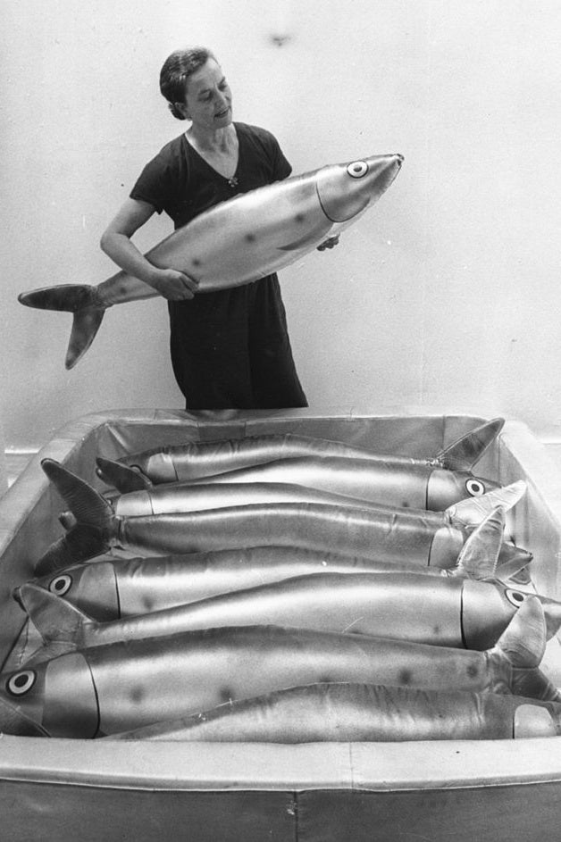 Claude places a replica of a giant sardine into a tin, as she and her husband prepare their exhibits at the Whitechapel Art Gallery in London