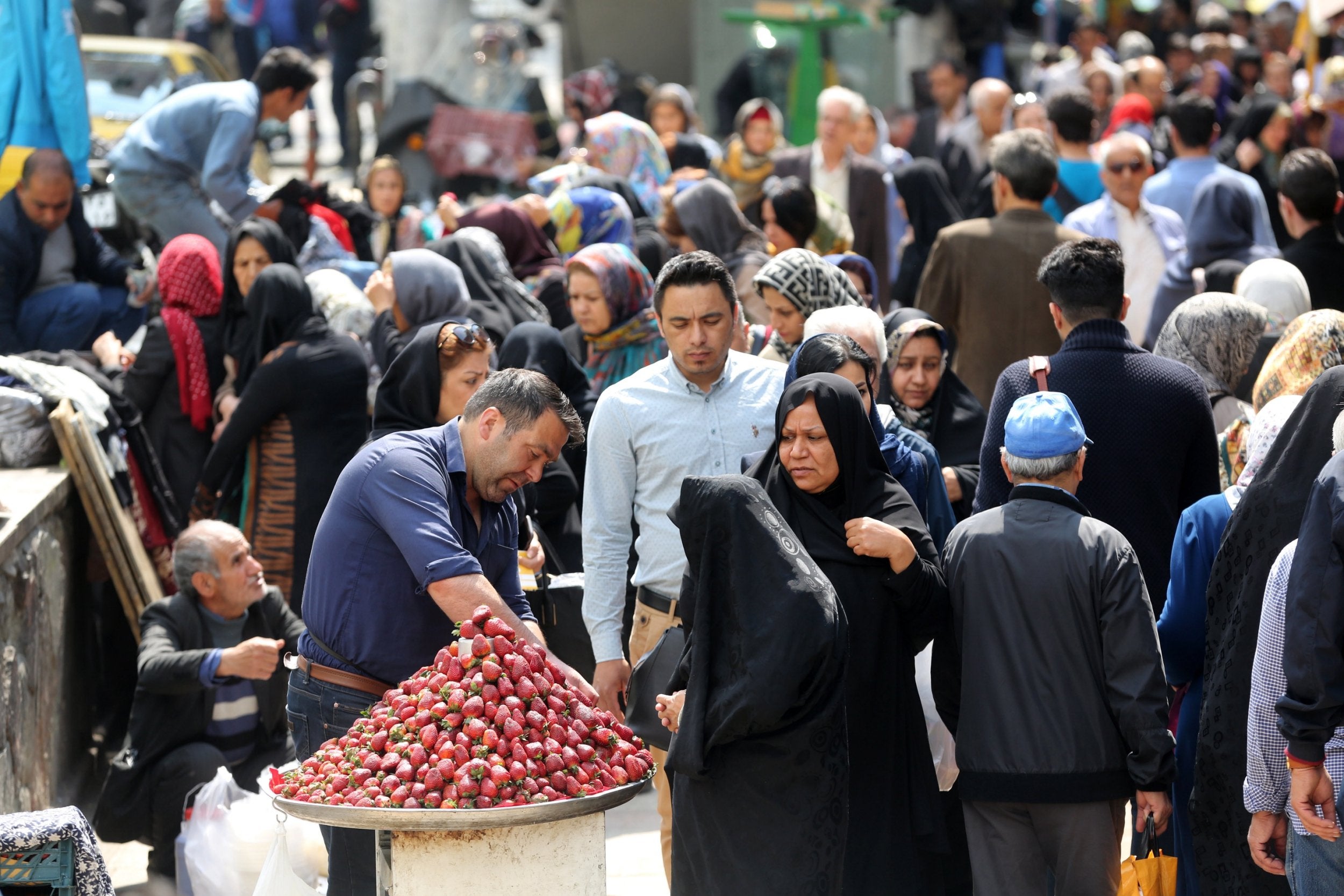 Iranians shop in a street of Tehran