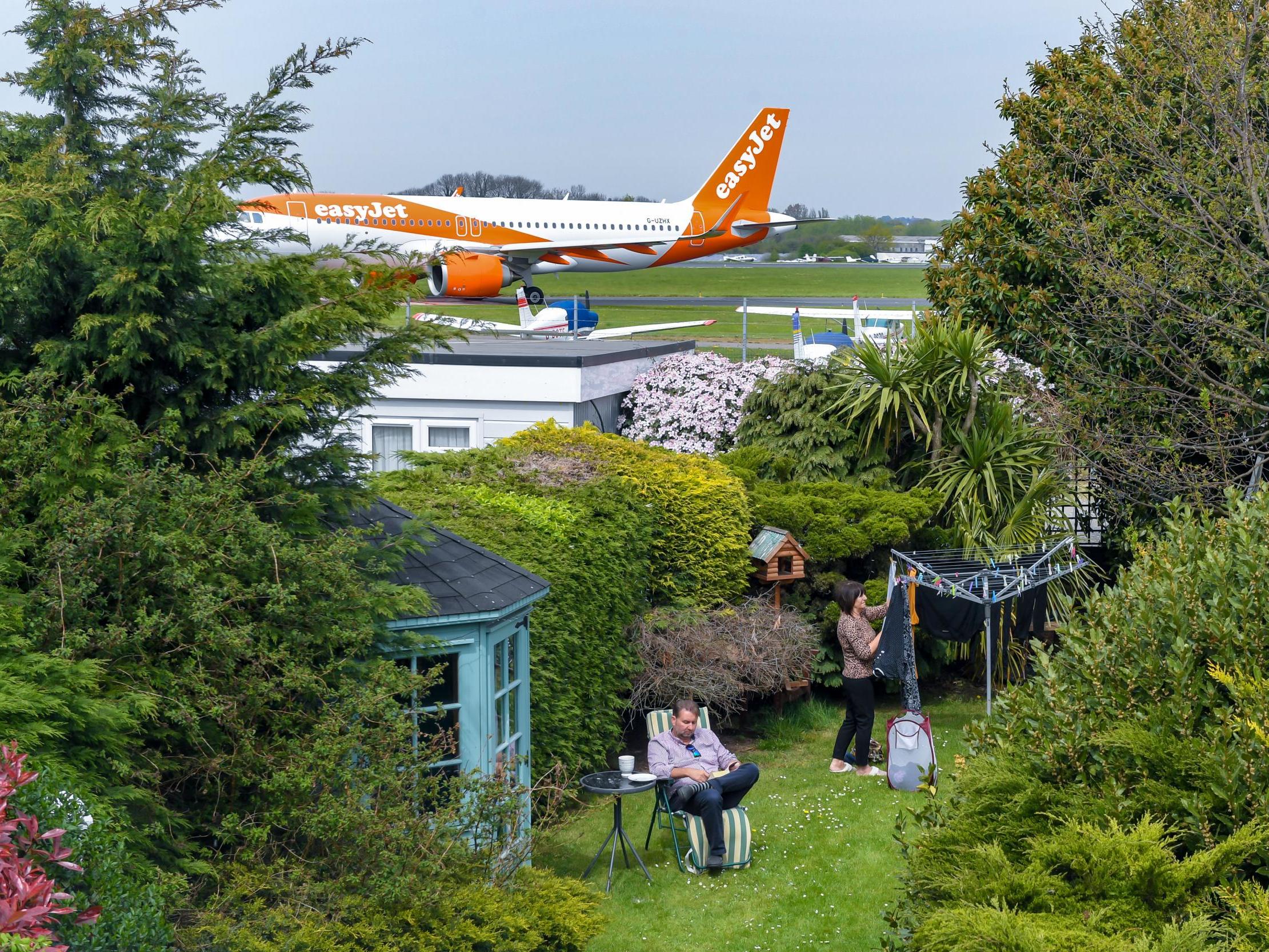 Alex and June Carr in their garden which backs on to Southend Airport in Essex