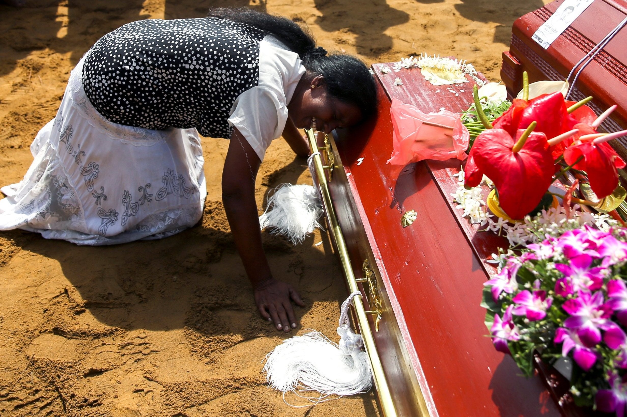 A woman reacts during a mass burial of victims, two days after a string of suicide bomb attacks on churches and luxury hotels across the island on Easter Sunday (Reuters)