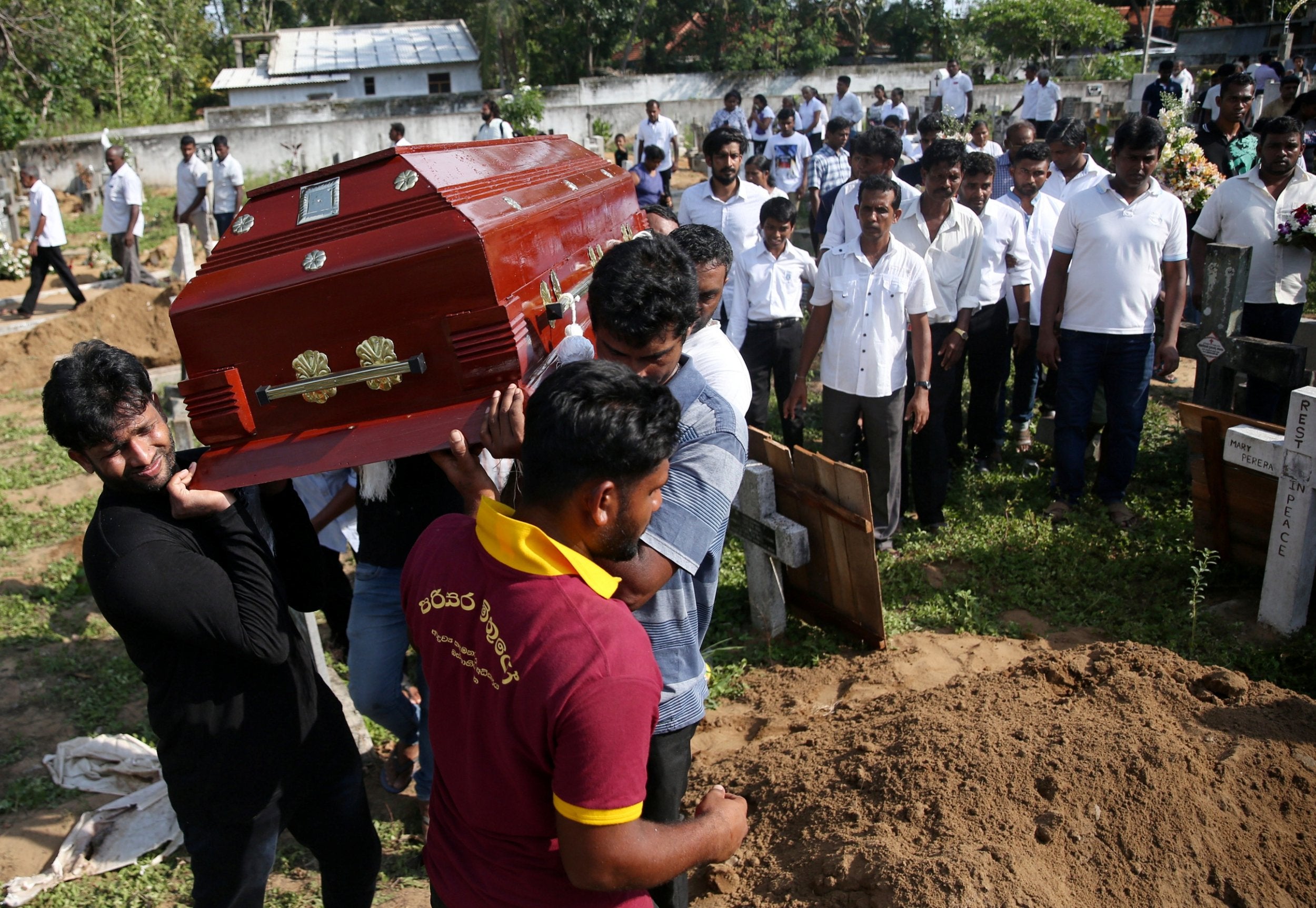 A coffin of a victim is carried at a cemetery near St Sebastian’s Church in Negombo (Reuters)