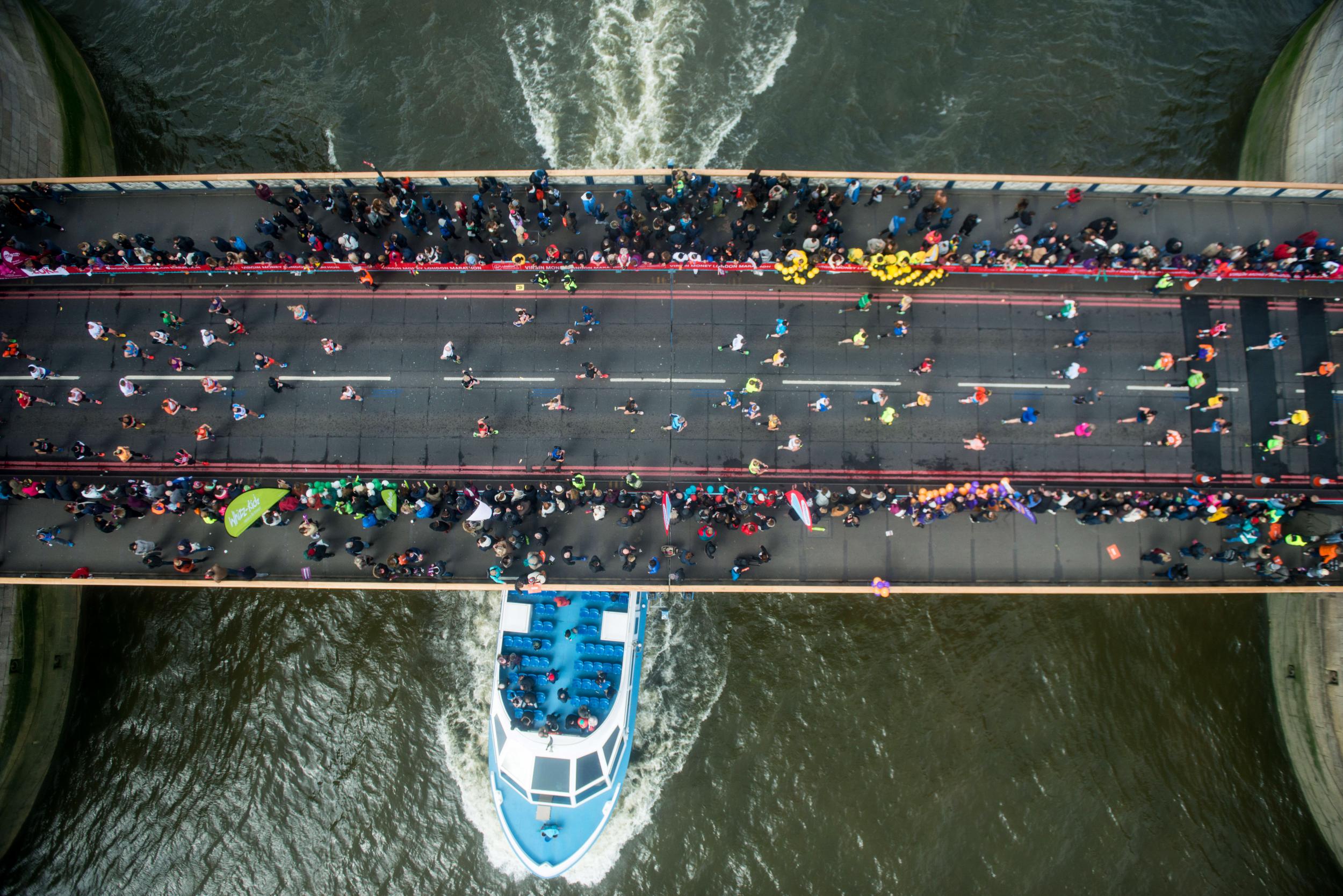 Runners cross the Rive Thames via Tower Bridge during the Virgin London Marathon 2016 on April 24, 2016 in London, England.