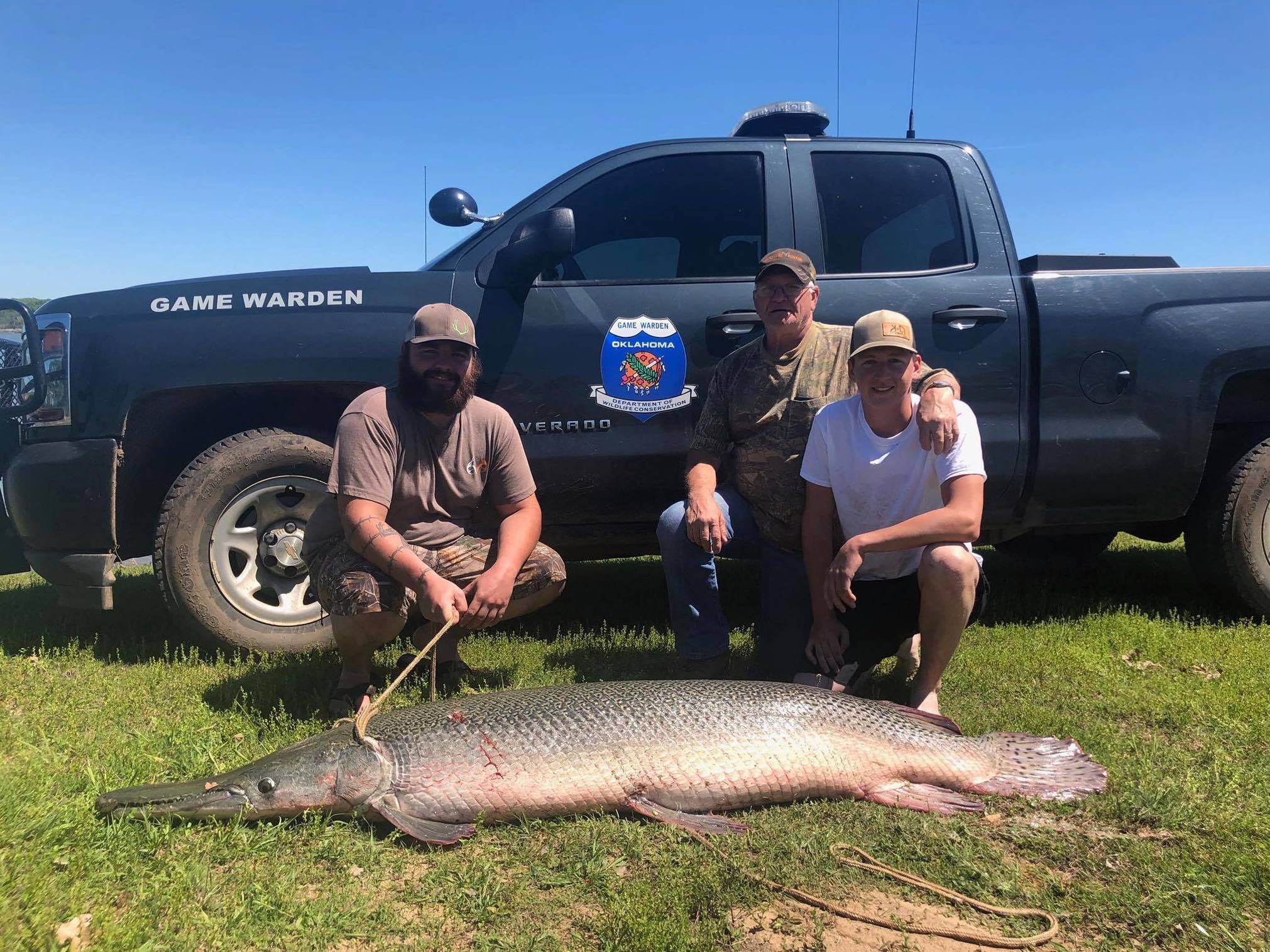 Zachary Sutterfield and two other anglers posed for a photo with the 'living fossil' alligator gar fish