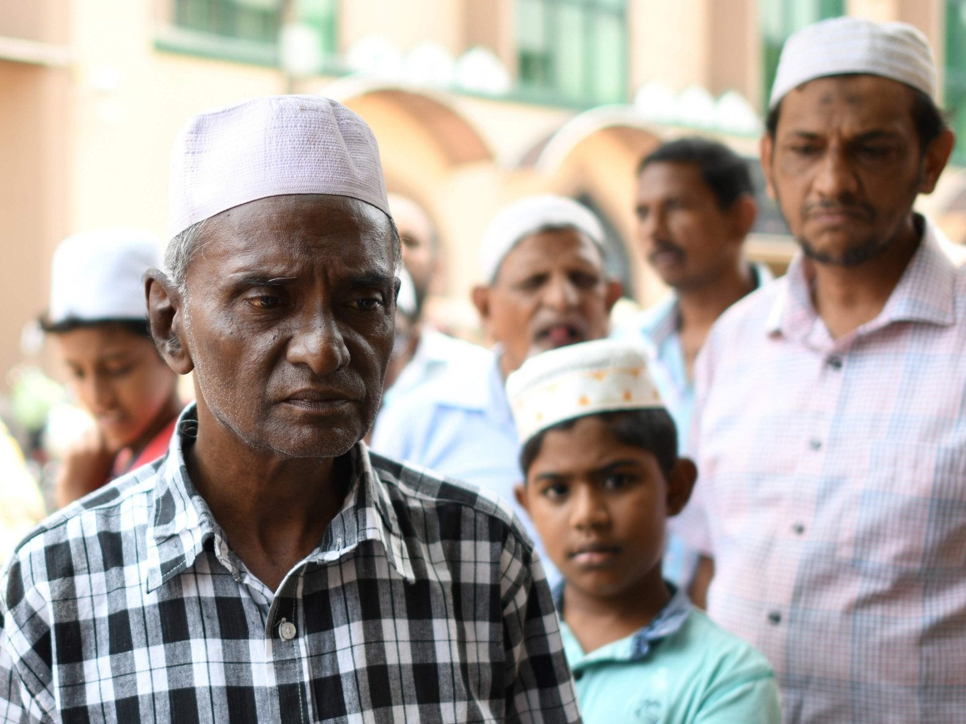 Members of Sri Lanka’s Muslim community gather outside the mosque in Colombo on Tuesday