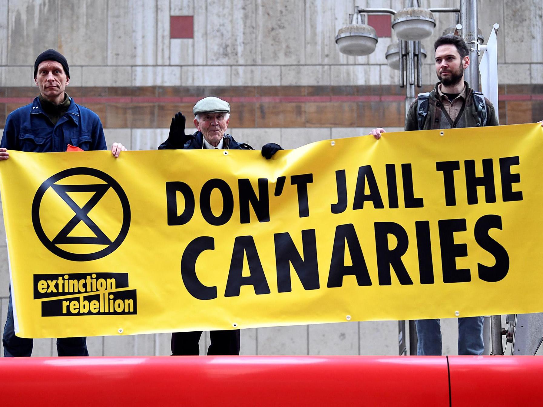 Activists stand on top of a train at Canary Wharf Station during Thursday's protest in London