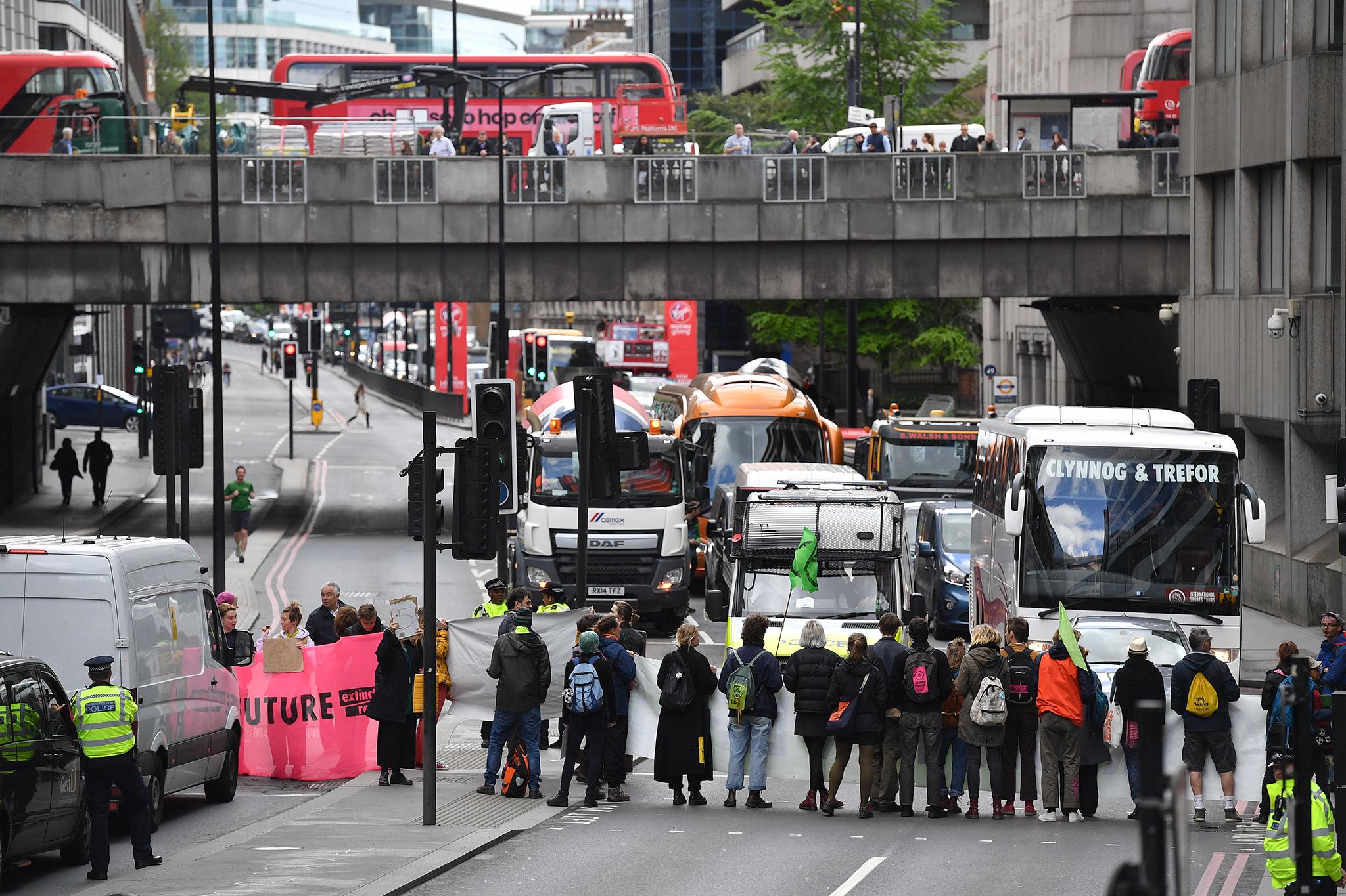 Protesters hold up traffic on Upper Thames Street in the City of London