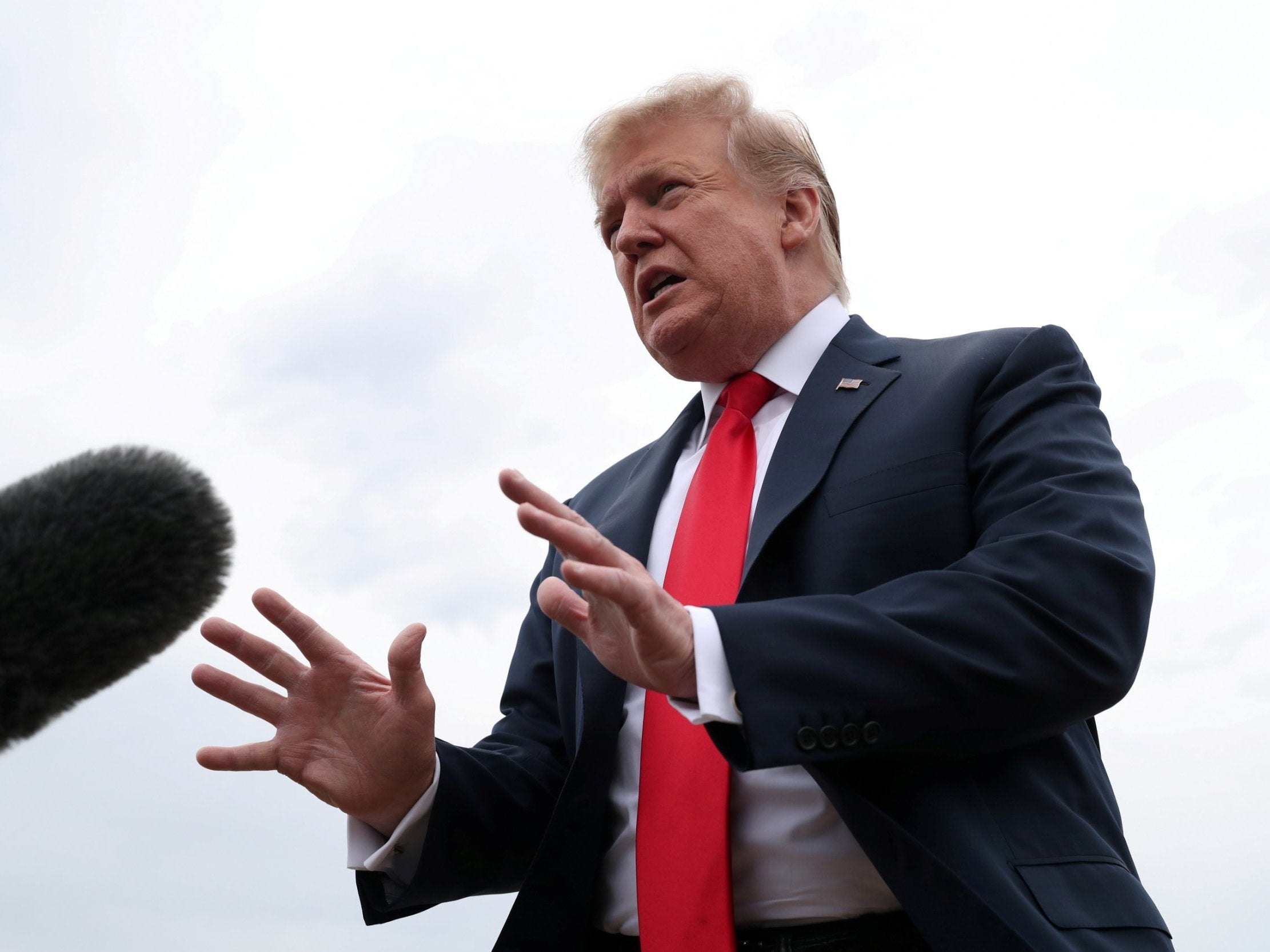 President Donald Trump speaks to reporters before boarding Air Force One for travel to Indianapolis, Indiana, at Joint Base Andrews, Maryland, on Friday