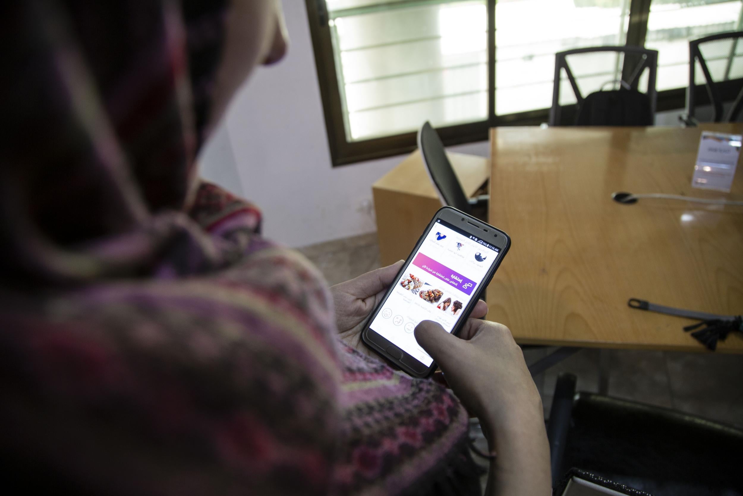 A Gazan mother shows her new app designed to help mothers in the Middle East