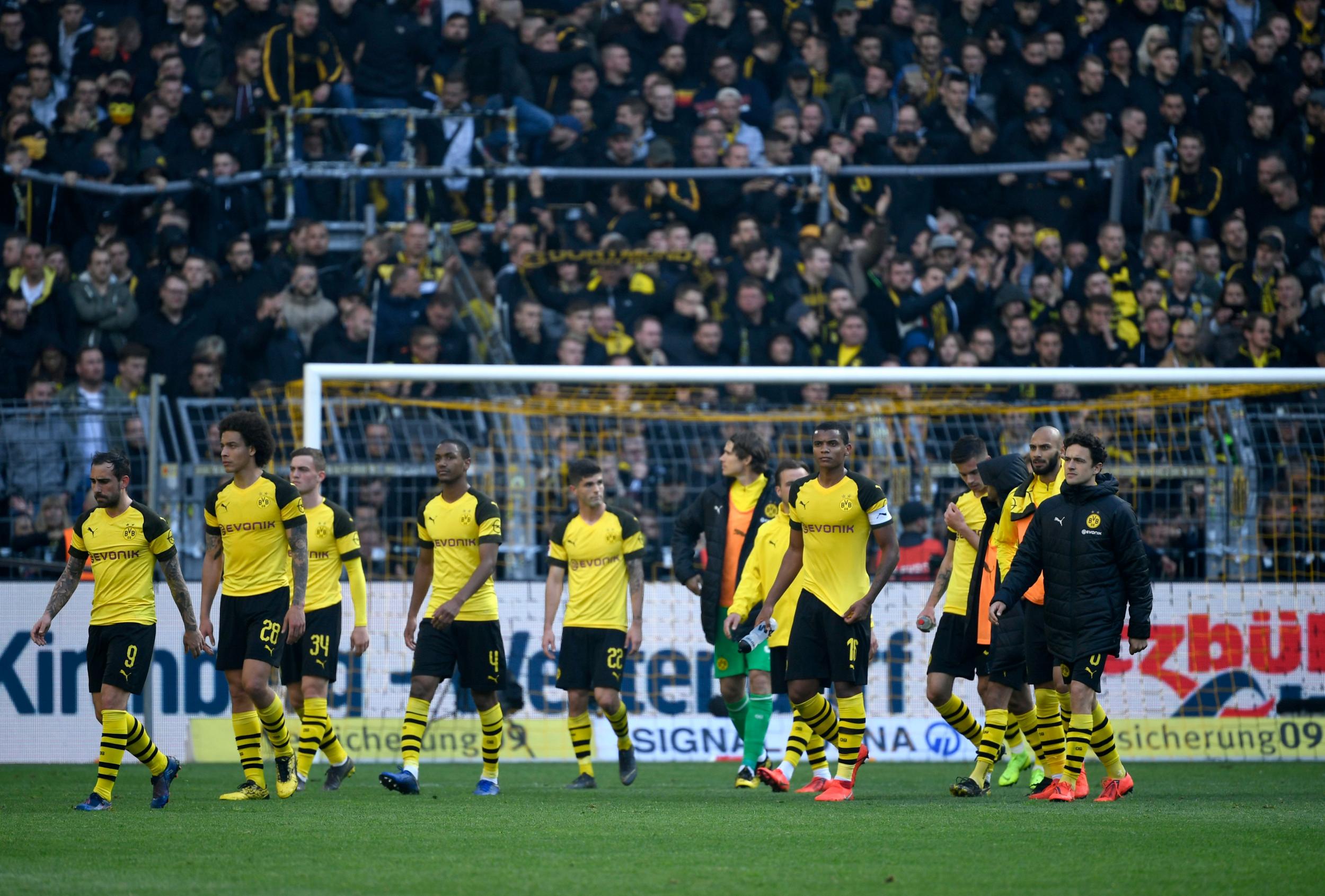 Borussia Dortmund players look crestfallen as rivals Schalke dent their title hopes