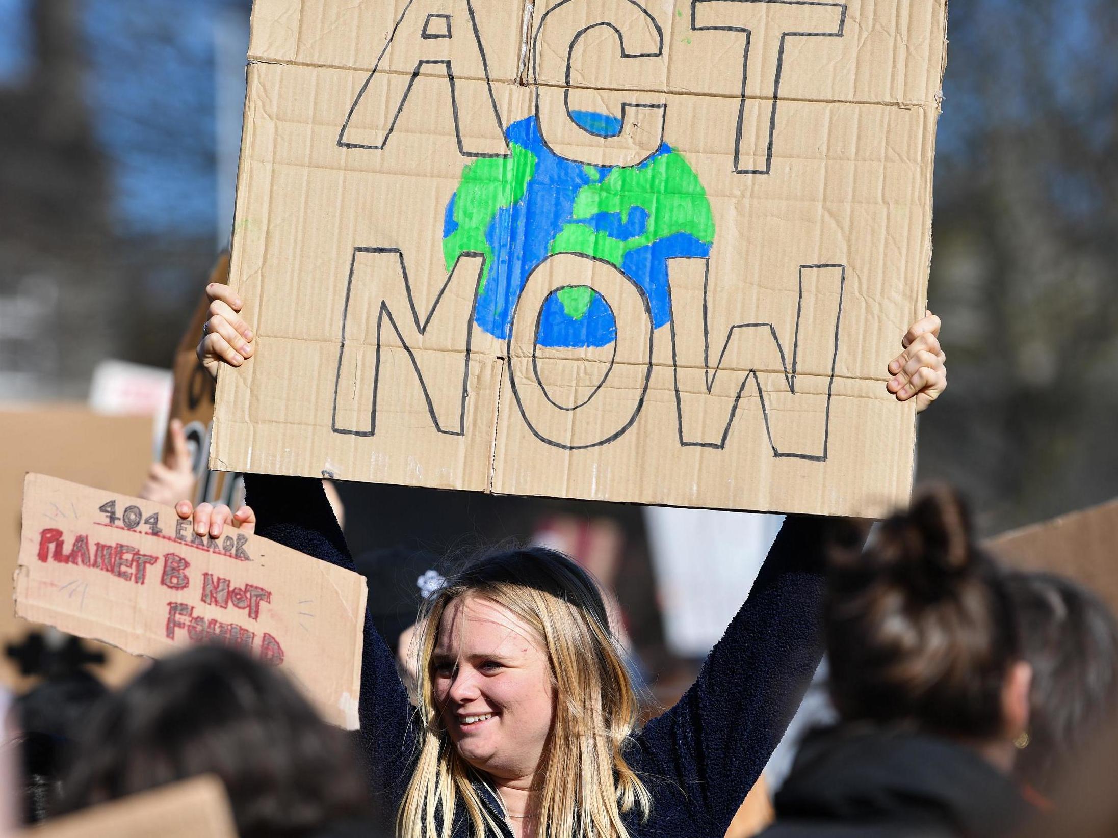 School pupils protest outside Scottish parliament in Edinburgh on 15 March