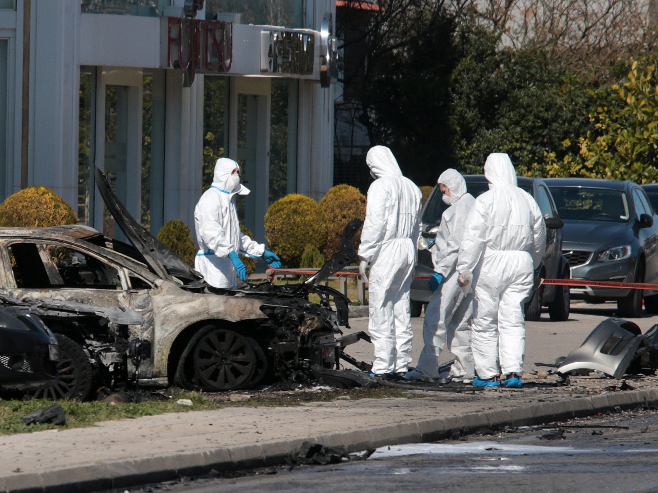 Police examine the wreckage. Twelve firemen and four fire engines responded to the incident