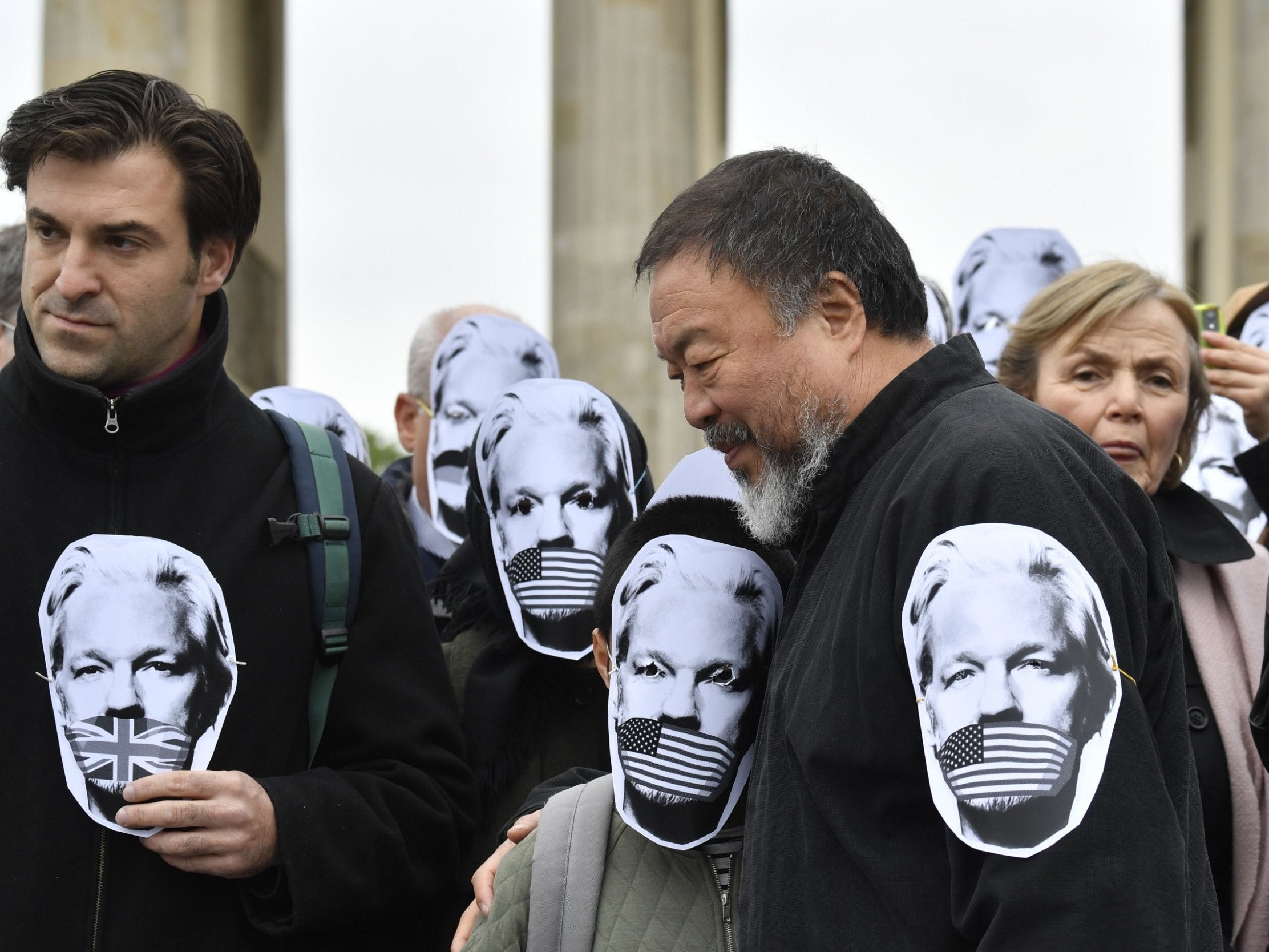 Ai Weiwei and pro-Assange demonstrators protest with masks of WikiLeaks founder in Berlin on Thursday (AFP/Getty)