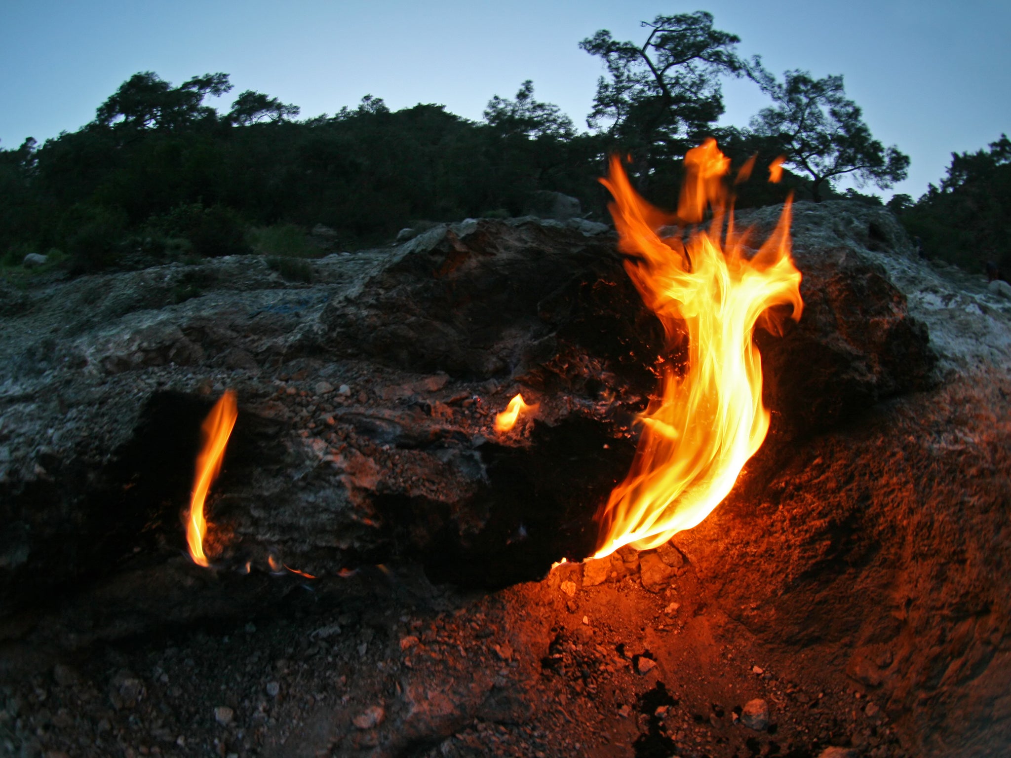 The Flames of Chimaera in Turkey are produced by a gas escaping from deep within the earth produced by chemosynthesis, a chemical reaction inside rocks