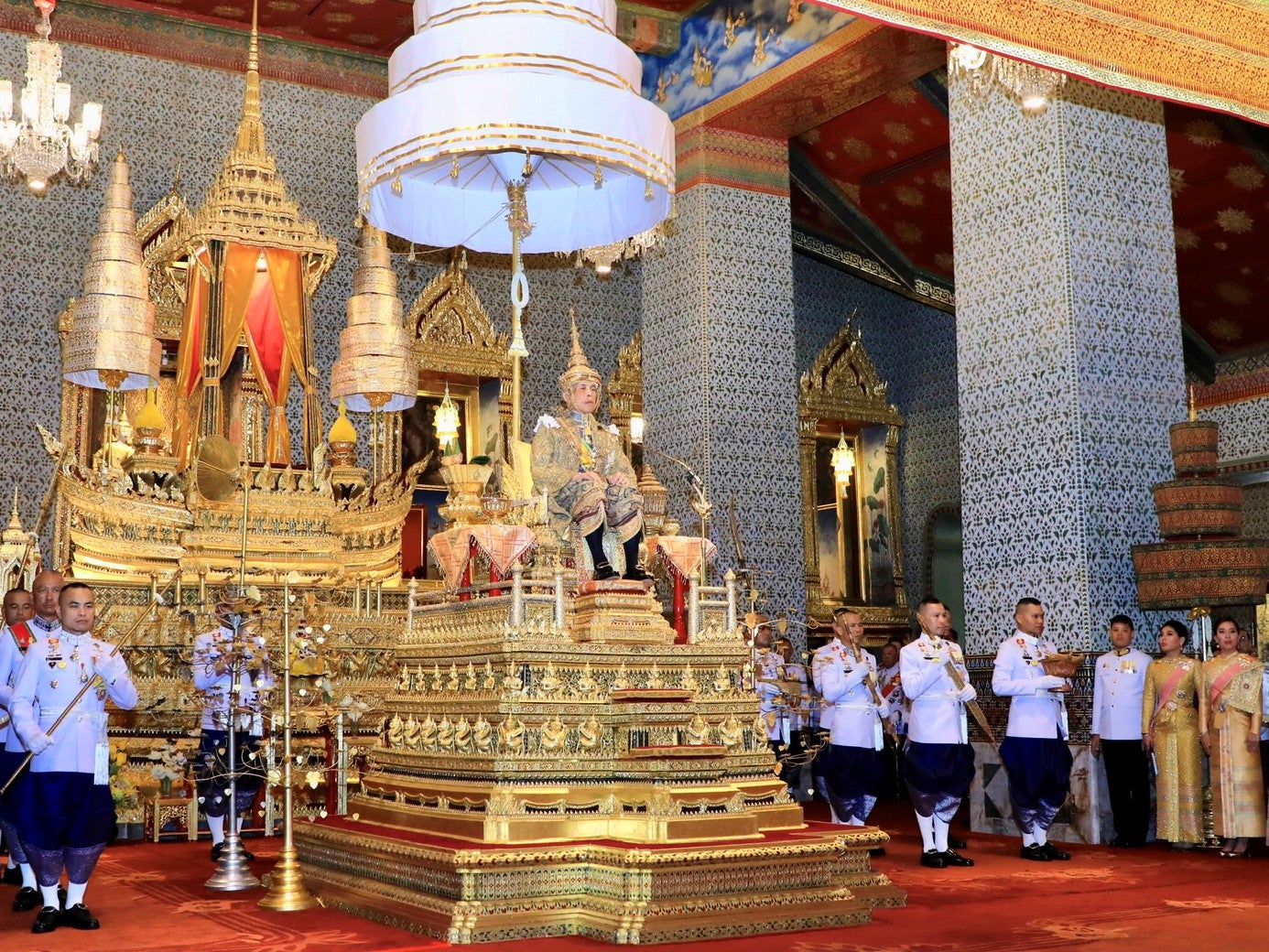 Thai King Maha Vajiralongkorn Bodindradebayavarangkun (C) sitting on the throne during his coronation ceremony at the Grand Palace in Bangkok