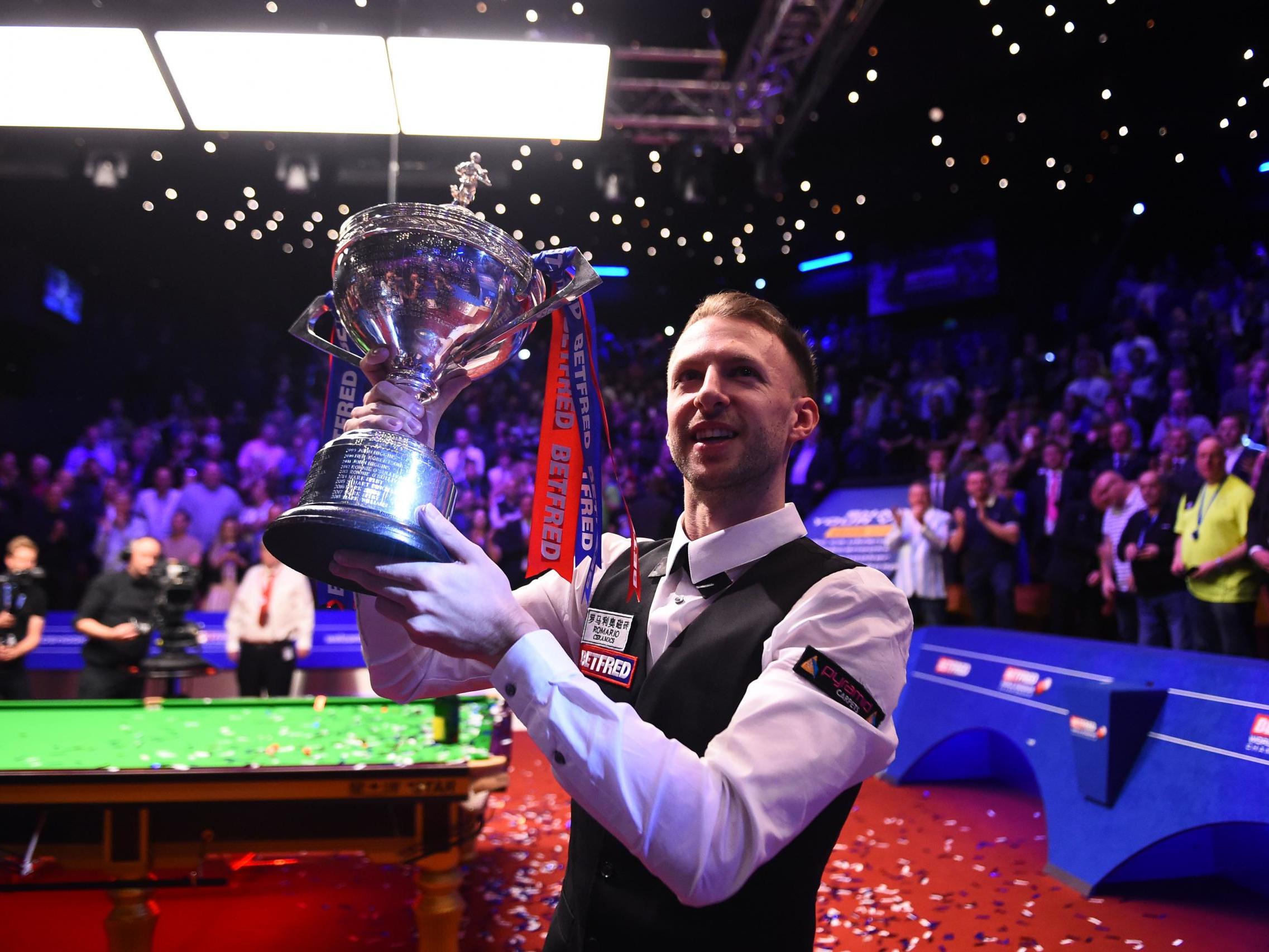 Judd Trump celebrates with the World Championship trophy