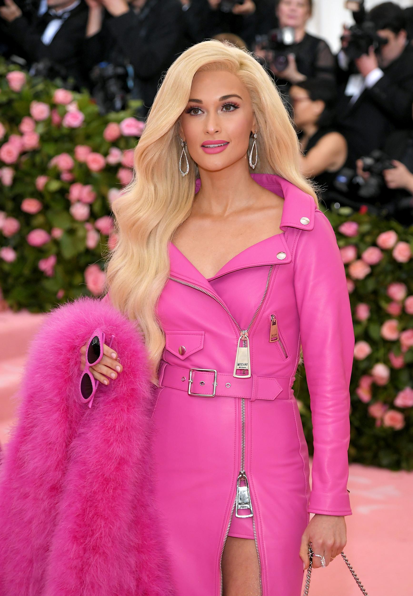 Kacey Musgraves takes inspiration from Barbie with her long blonde hair and pink ensemble
