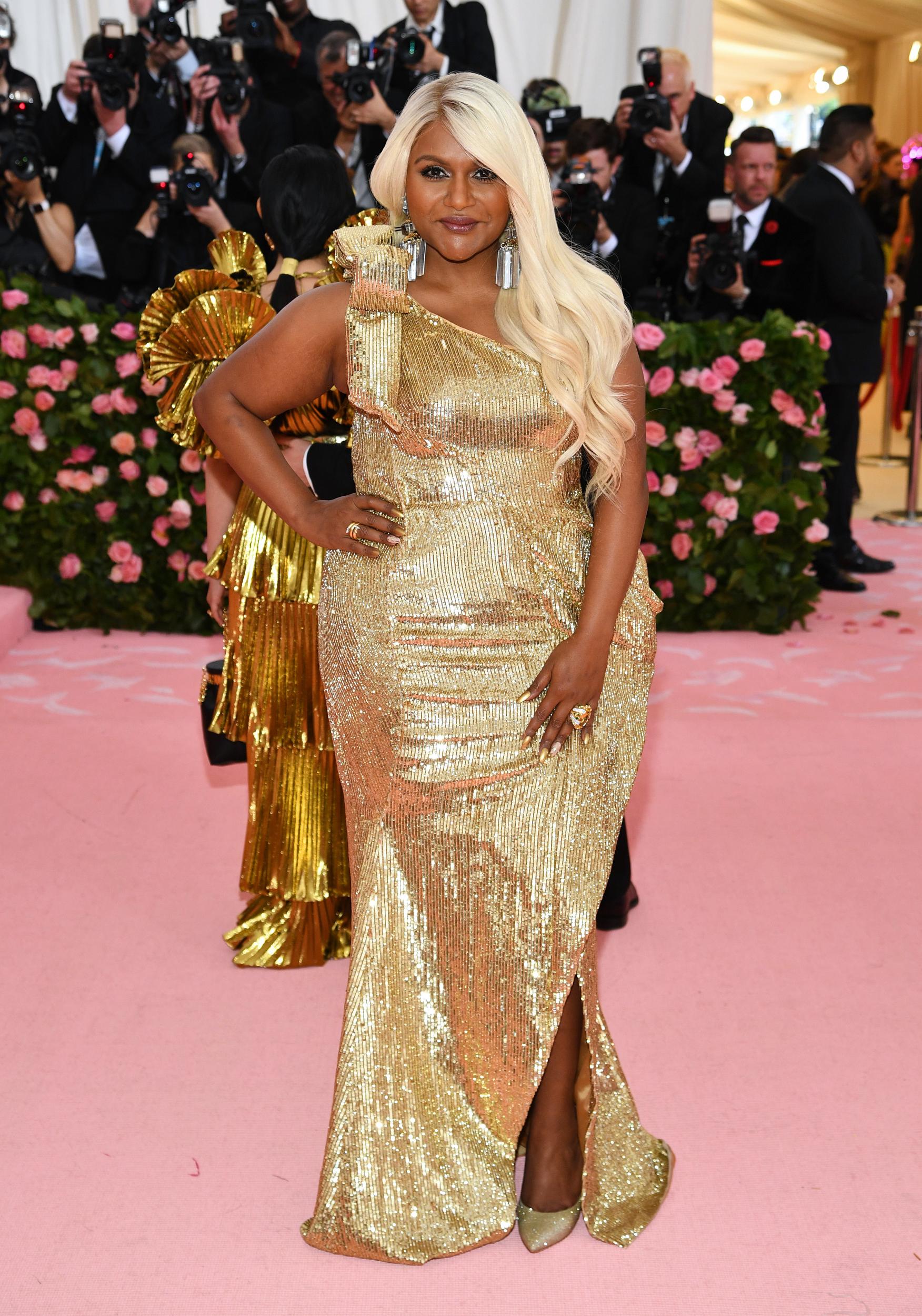 Mindy Kaling wears a gold Moschino gown at the Met Gala 2019