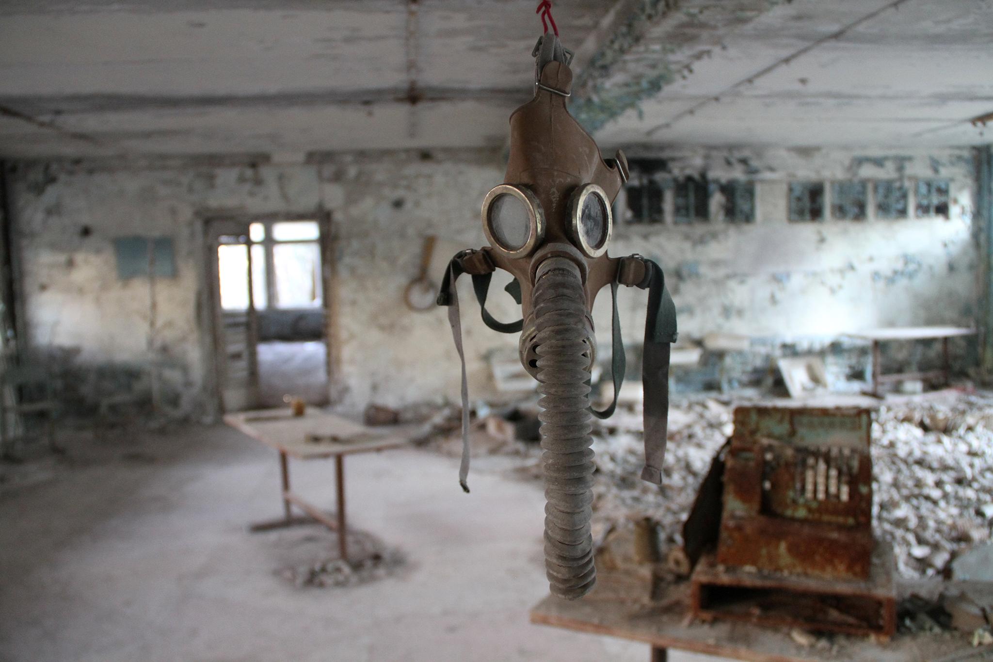 A gas mask hangs in a building inside the Chernobyl Exclusion Zone