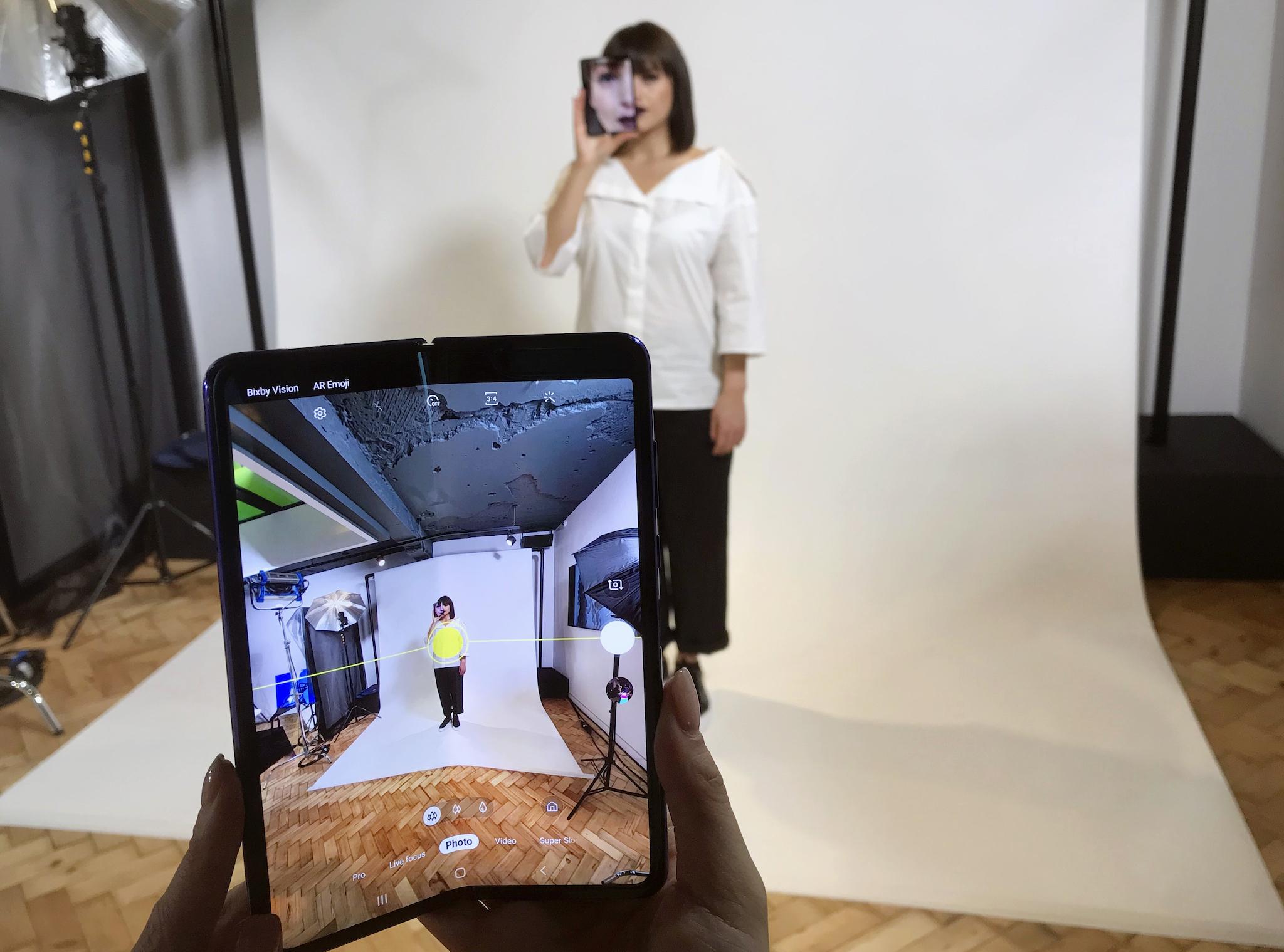 A model holds a Samsung Galaxy Fold smart phone to her face, during a media preview event in London