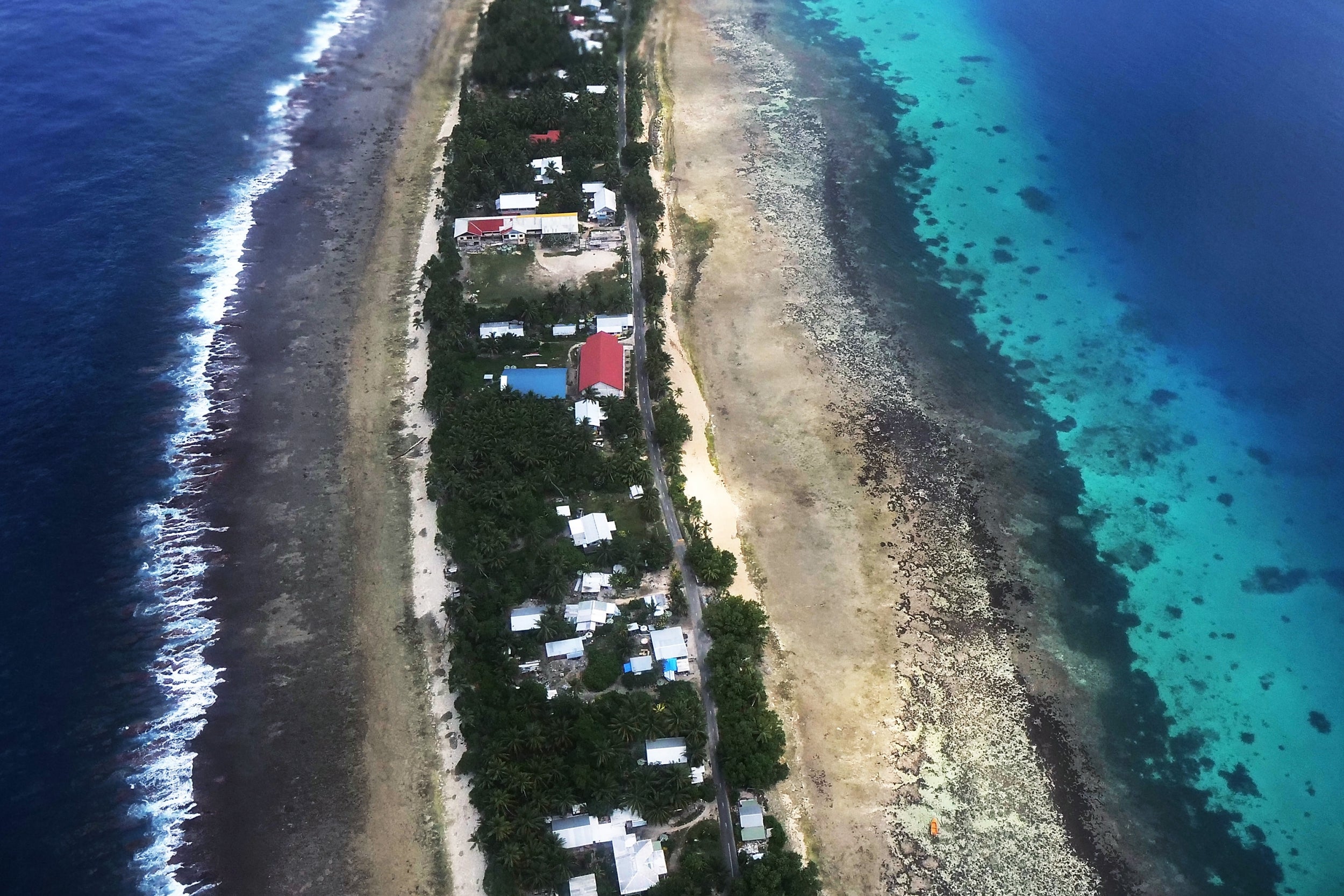 From the air the ocean (L) and the logoon (R) and separated by a thin stip of land in Funafuti, Tuvalu