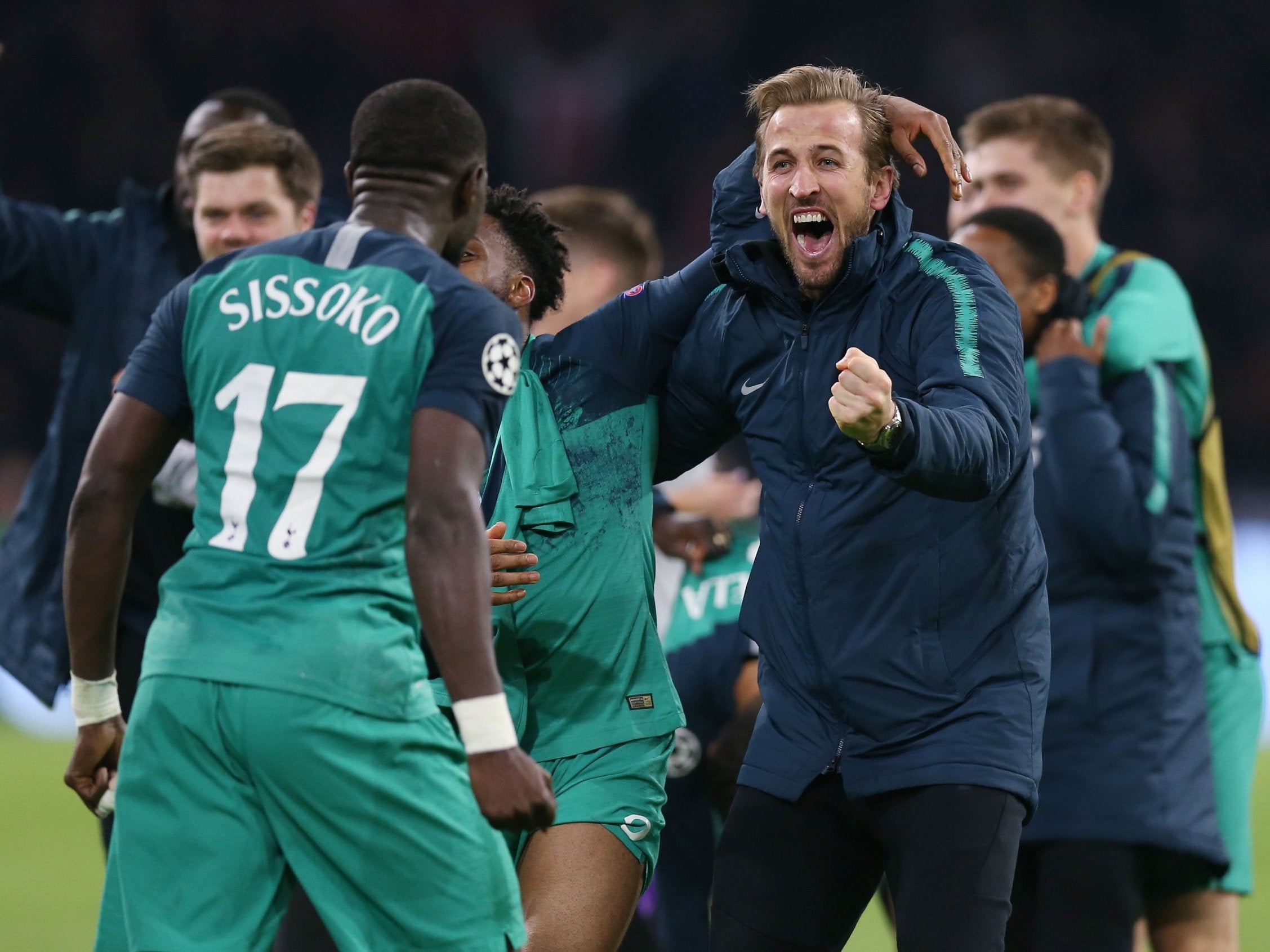 Harry Kane runs to embrace Moussa Sissoko after victory over Ajax