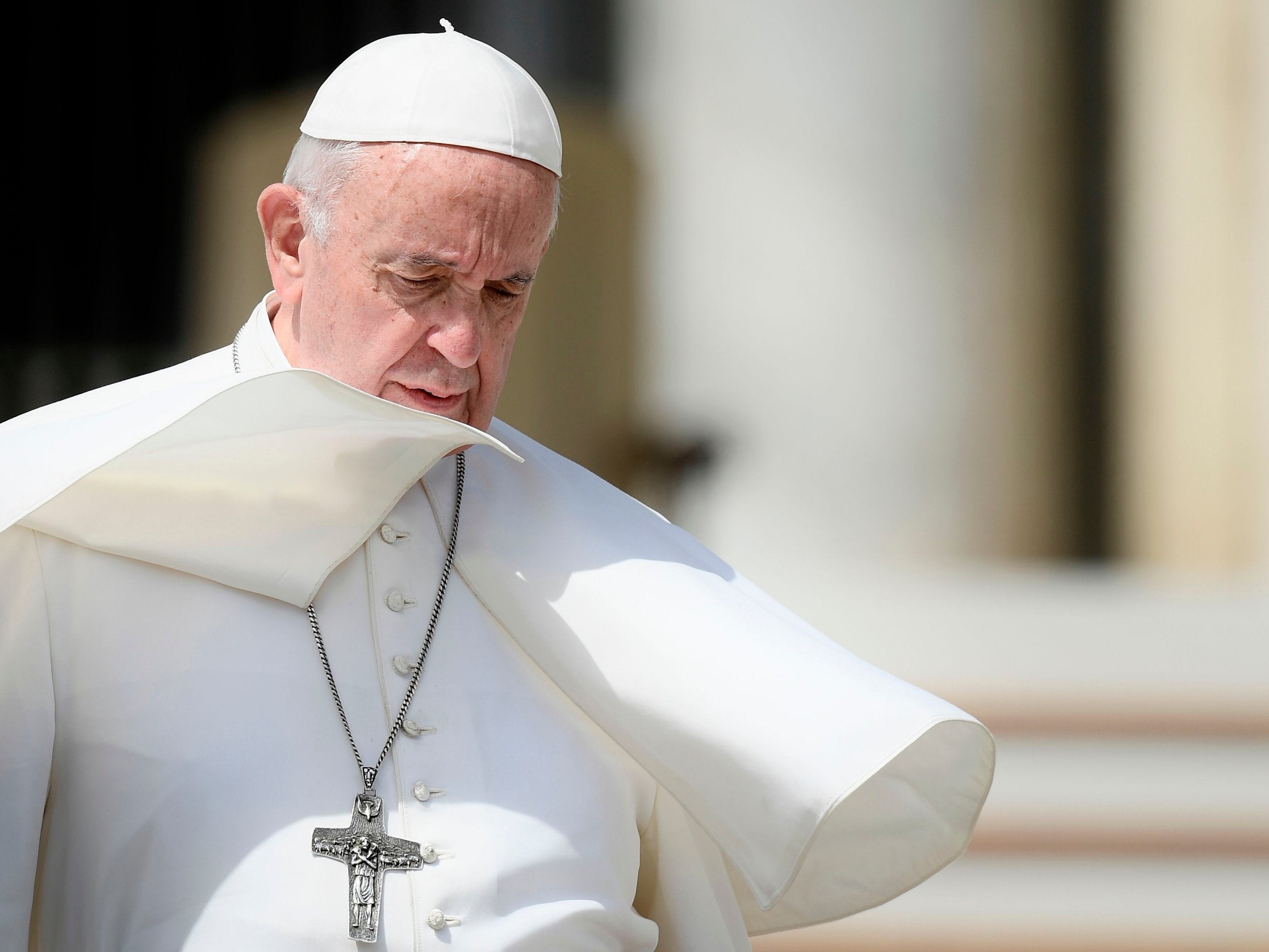 A gust of wind blows Pope Francis' cassock as he leaves at the end of the weekly general audience on 8 May at St Peter's square in the Vatican