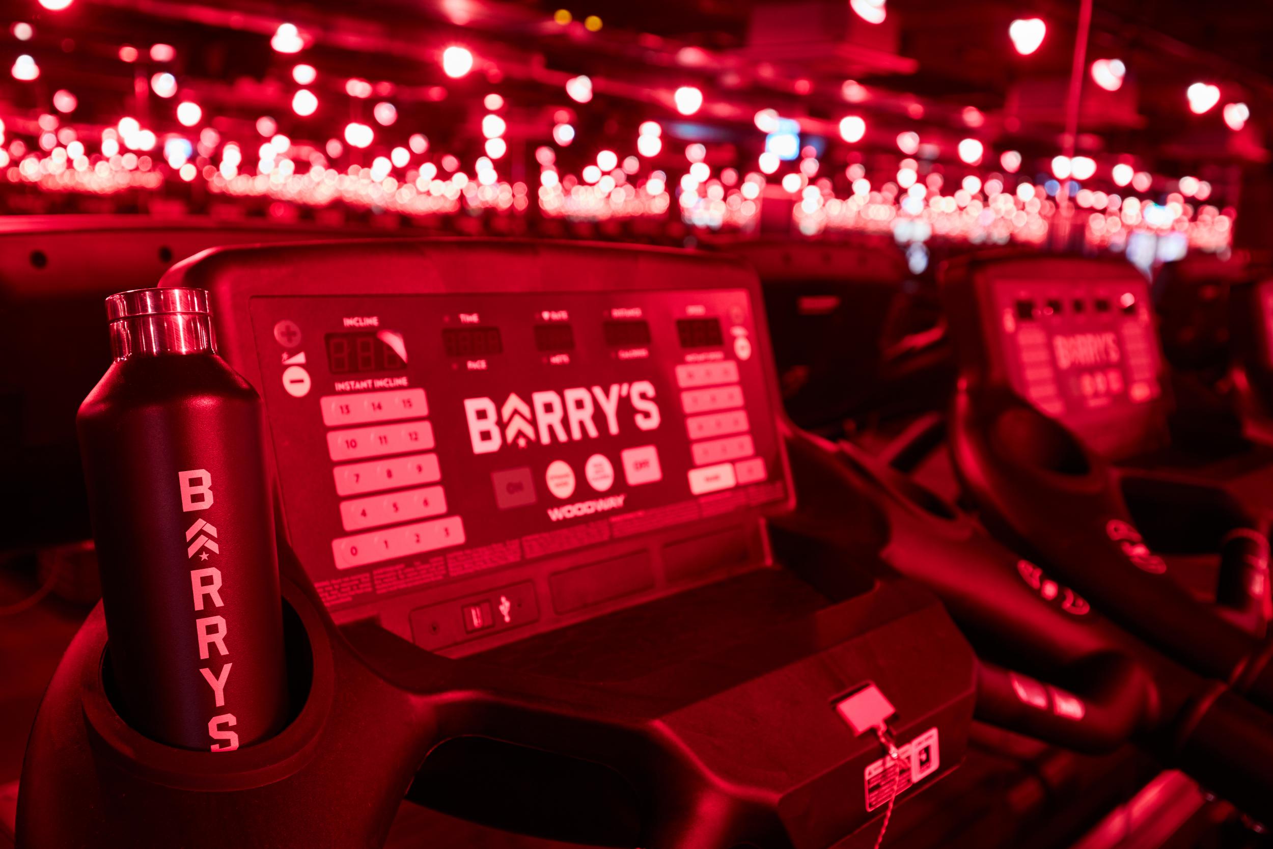 The studios boast seductive red lighting evoking a nightclub-meets-boudoir vibe (Barry’s Bootcamp)