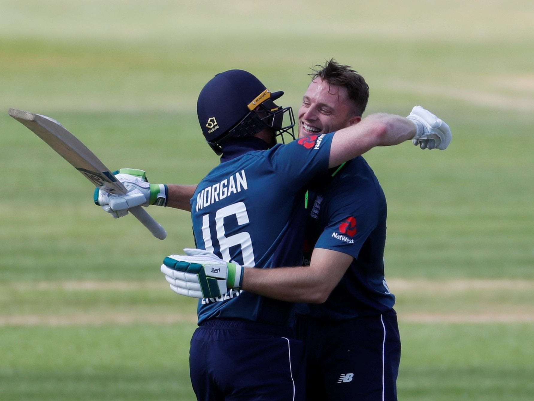 Jos Buttler celebrates reaching hiss century with England captain Eoin Morgan