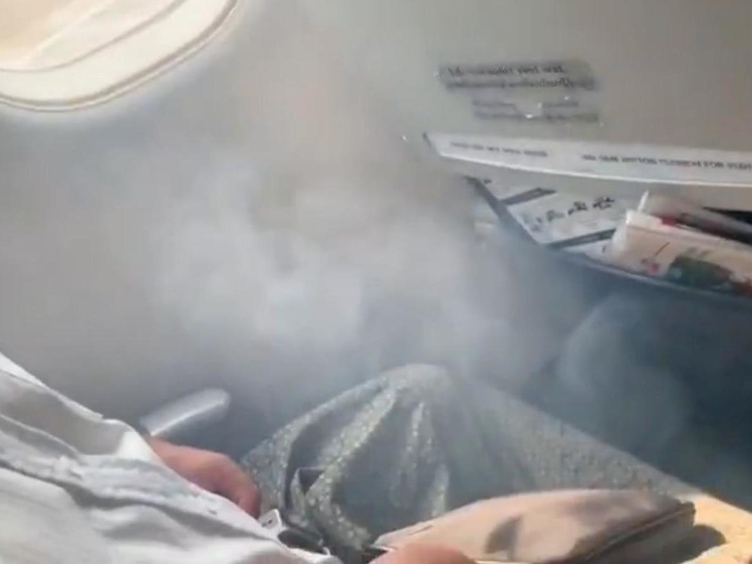 Smoke enters the cabin as passengers wait to evacuate flight UB103 from Yangon to Mandalay