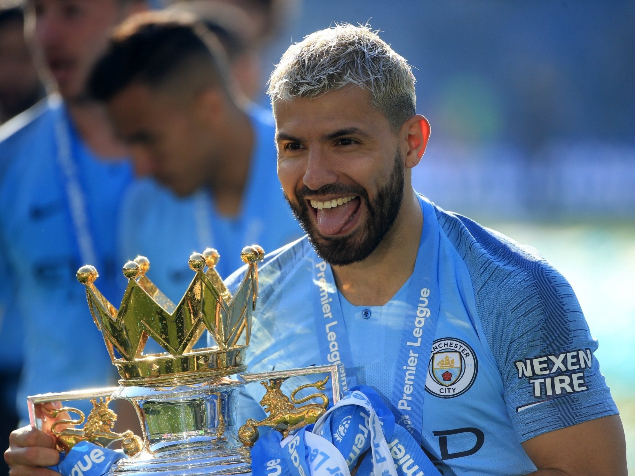 Sergio Aguero celebrates with the Premier League trophy