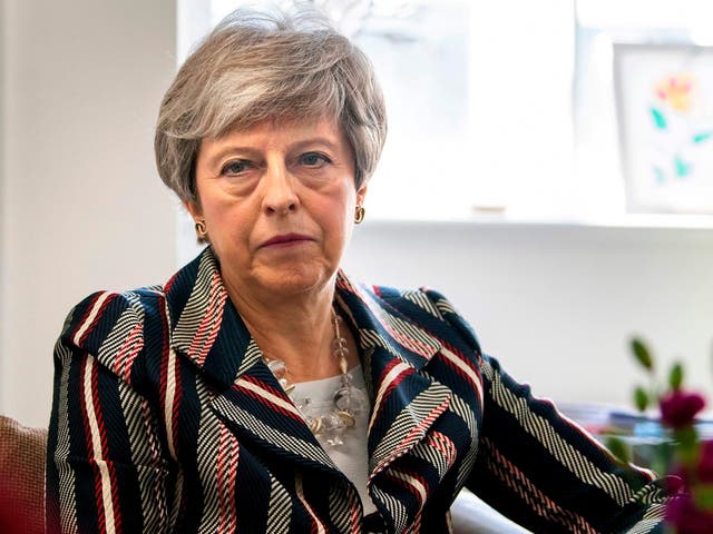 Theresa May talks with case workers and domestic violence survivors on a visit to a charity providing support for victims of domestic violence in west London