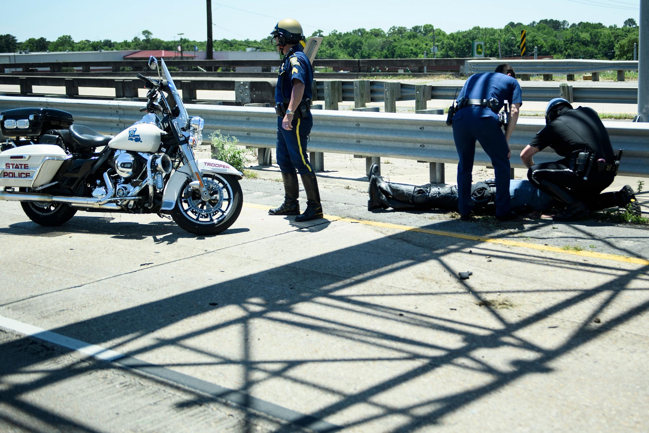 An officer was pictured lying down and receiving assistance after the crash. (BRENDAN SMIALOWSKI/AFP/Getty Images)