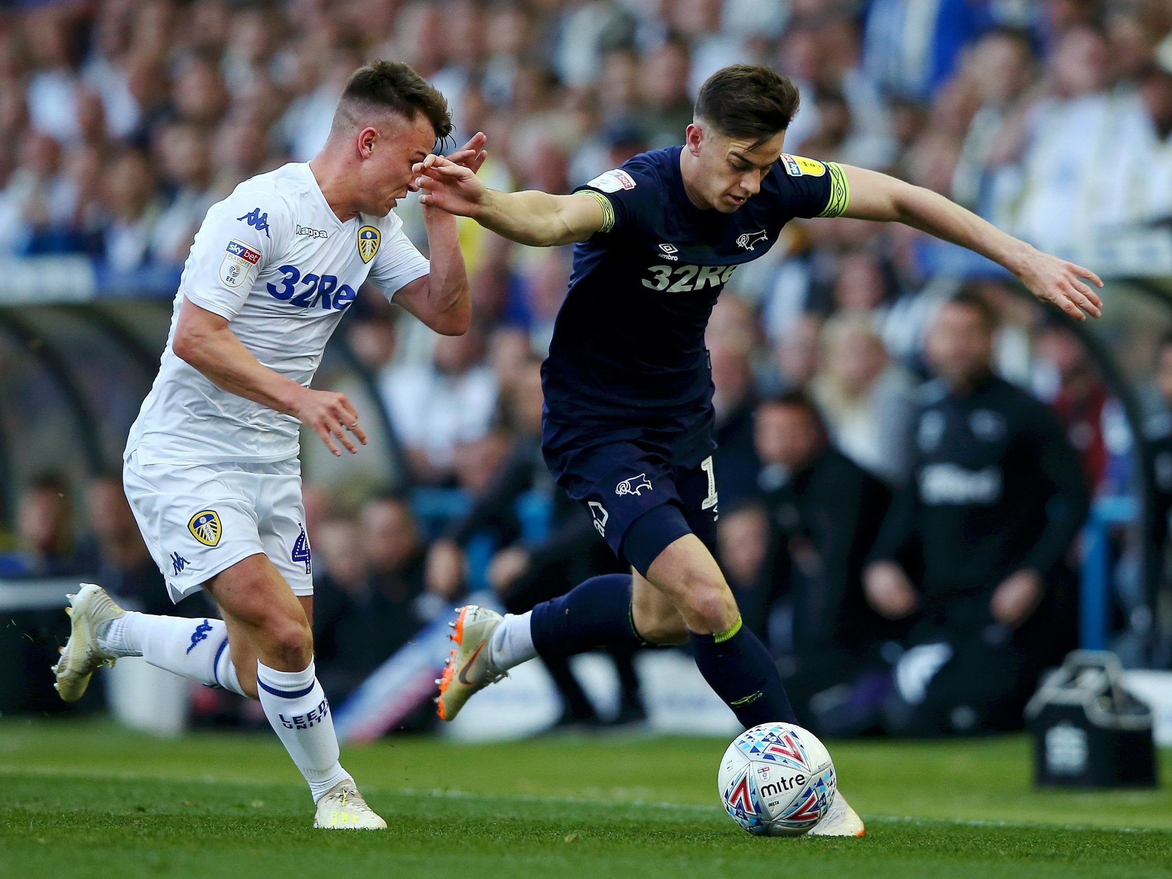 Tom Lawrence is challenged by Jamie Shackleton