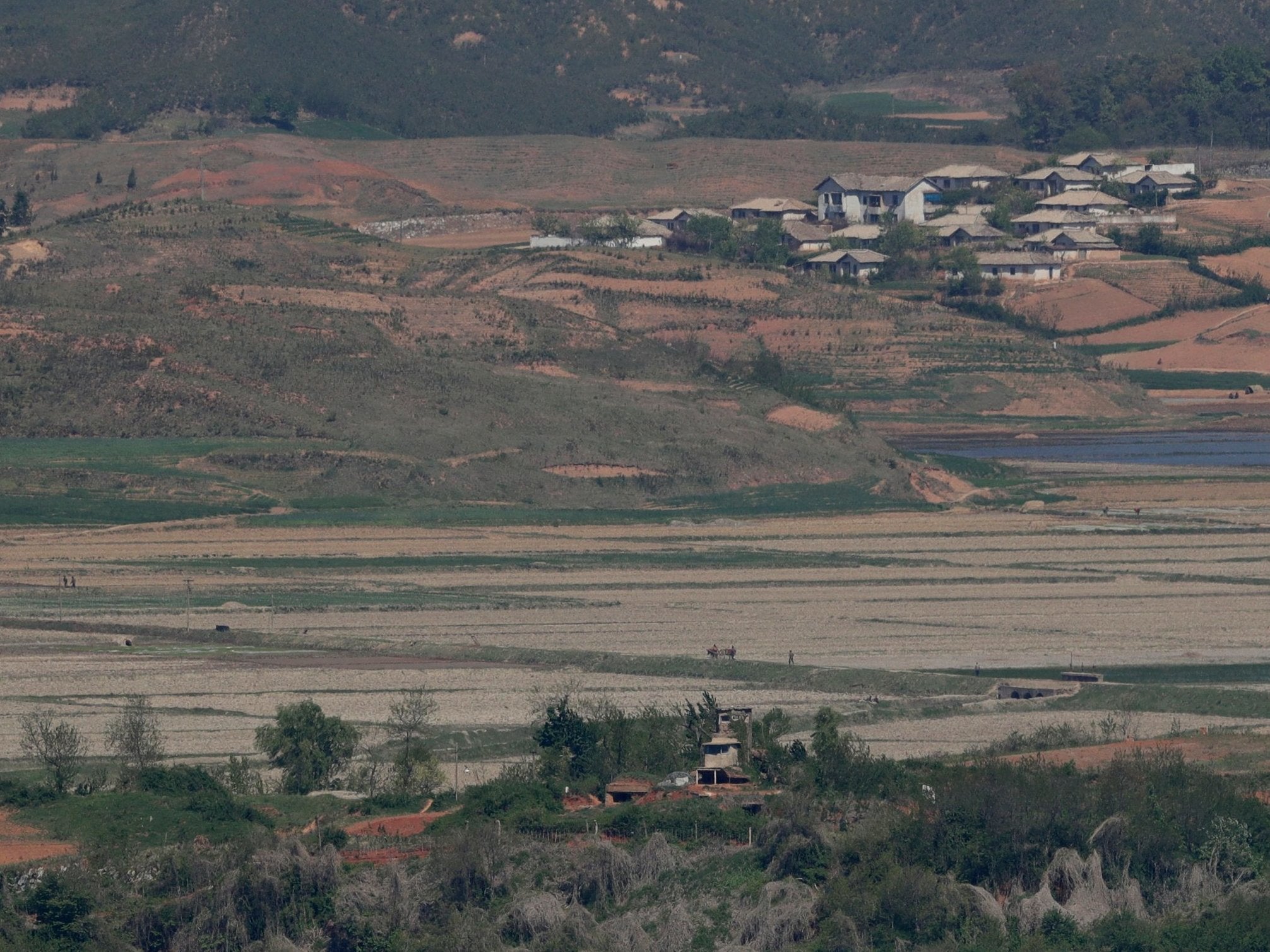 North Korea's Kaepoong town is seen behind a military guard post, bottom, as the country suffers its worst drought since 1982