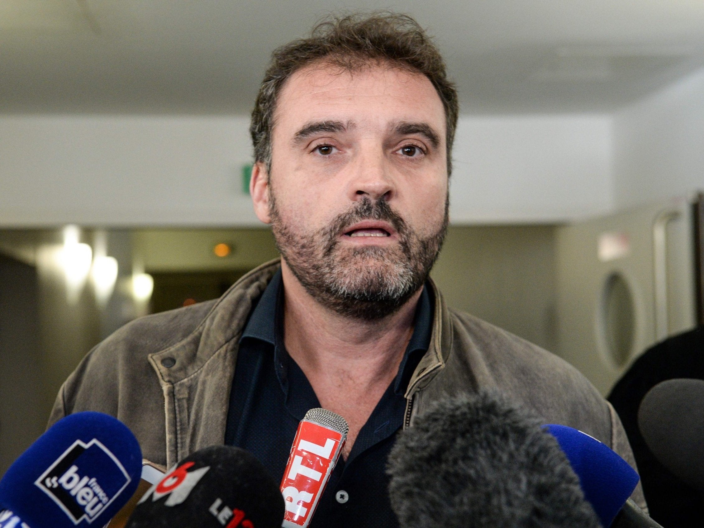 Frederic Pechier speaks outside court in Besancon, France, after being charged with 17 further poisonings