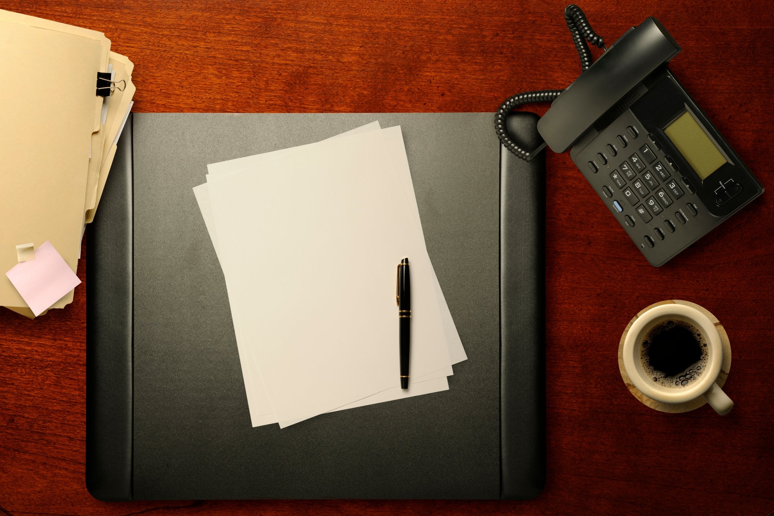 Desk staples: pen, paper and landline phone... not a device connected to the internet in sight