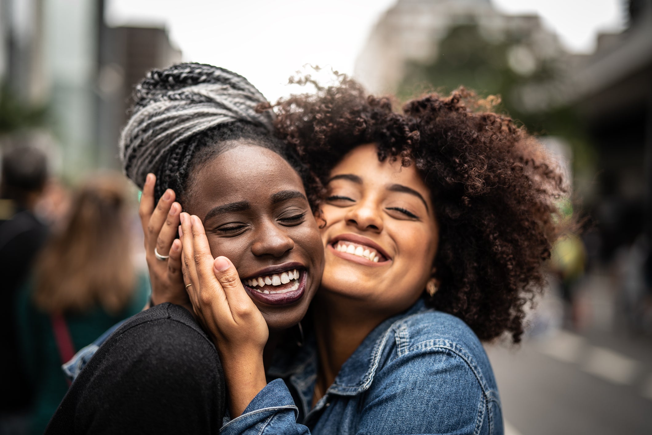 Two women photographed smiling together