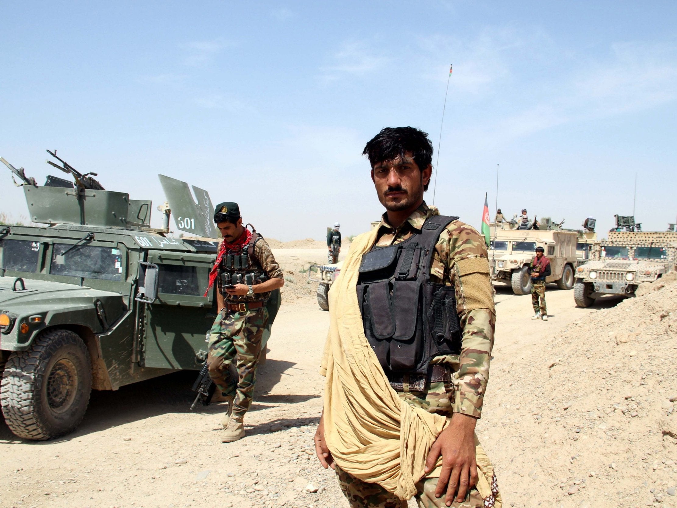 Afghan security officials on patrol in Helmand province, Afghanistan, on Friday