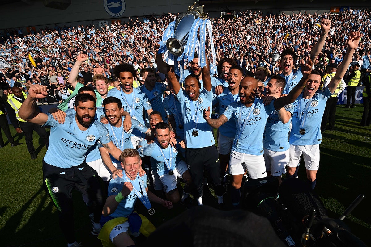 Man City celebrate their latest title at Brighton (AFP/Getty)